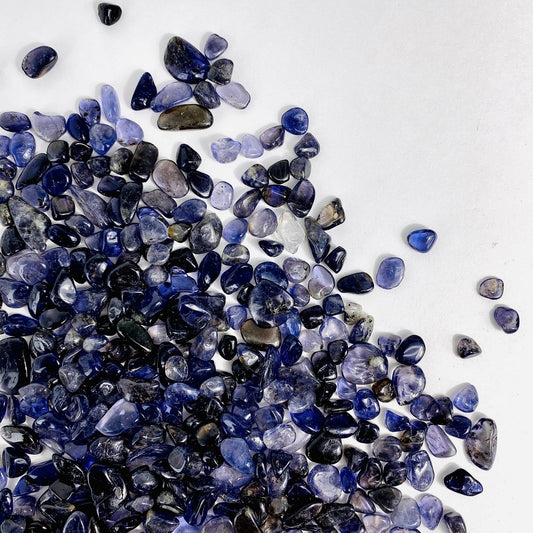 1lb Bag of Iolite Chips spread out on a table