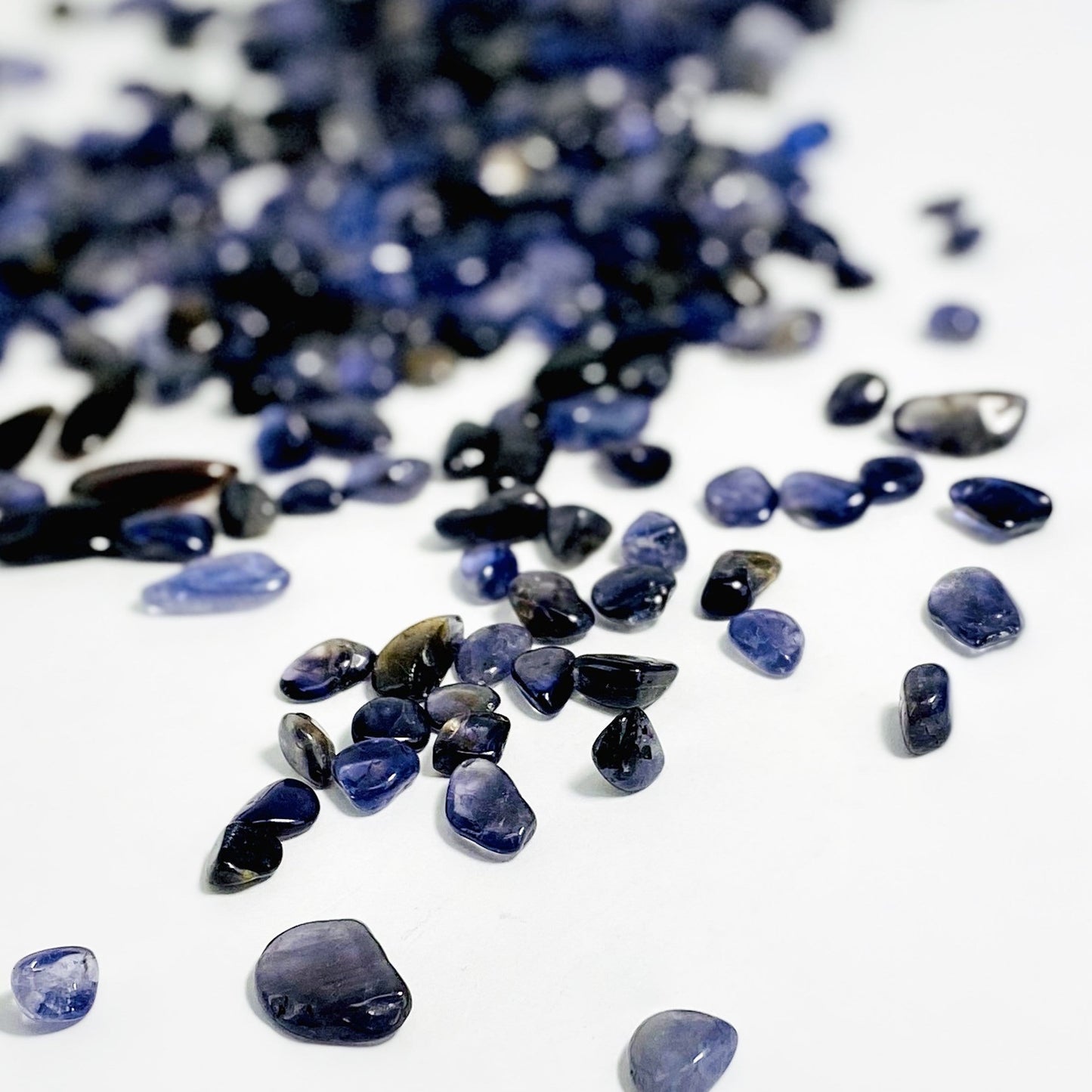 1lb Bag of Iolite Chips spread out showing side view up close
