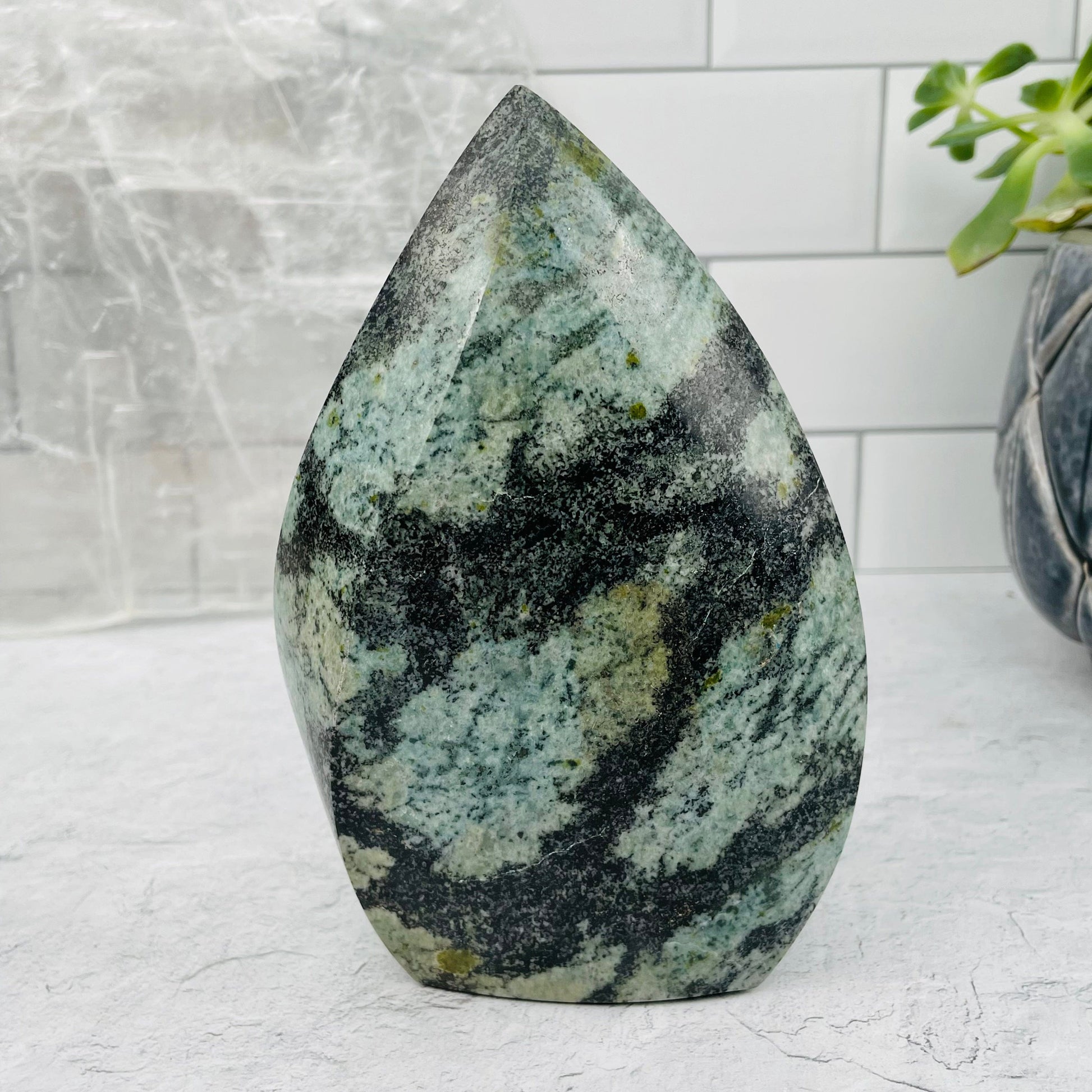 Green Snake Skin Jasper Flame displayed as home decor 