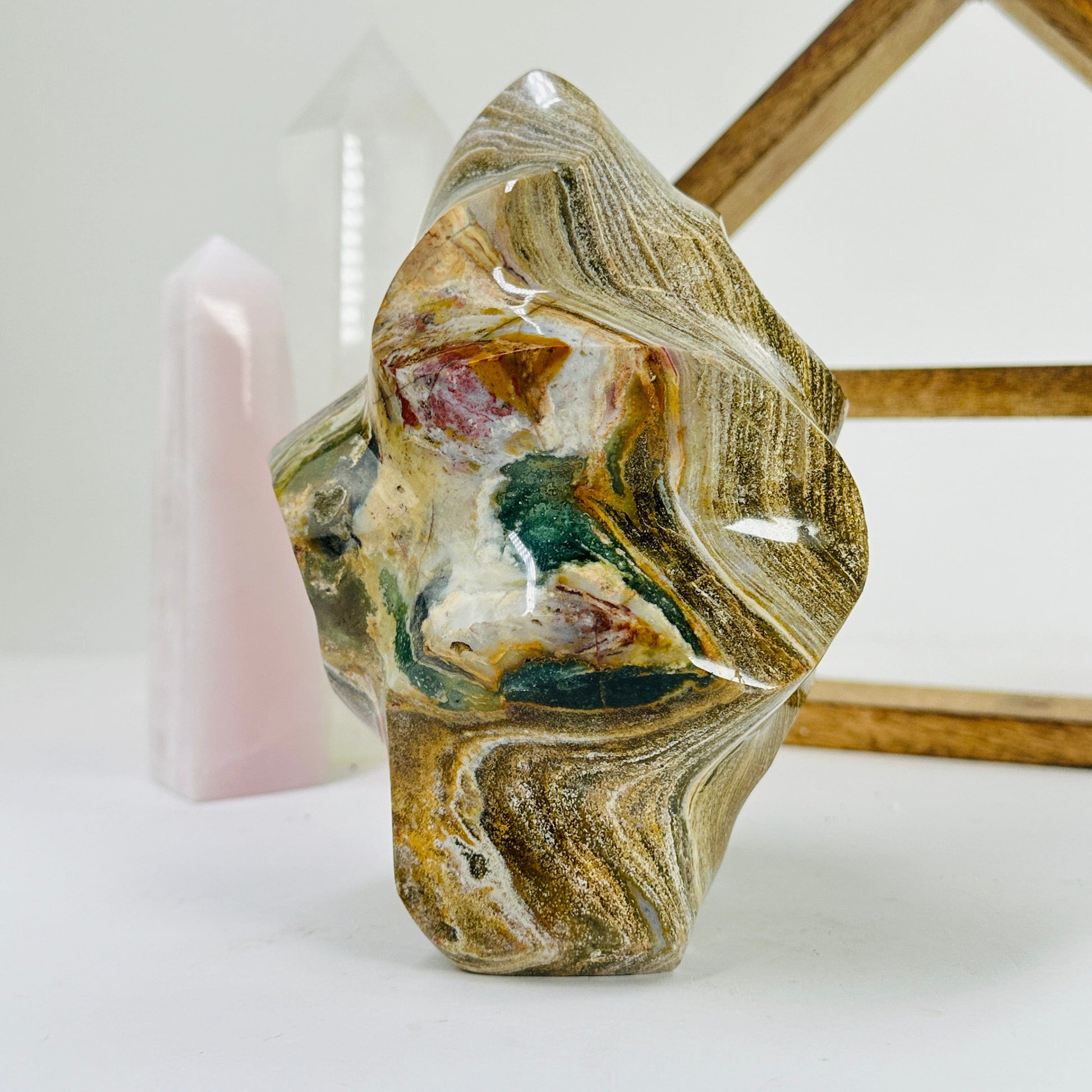 ocean jasper flame point with decorations in the background