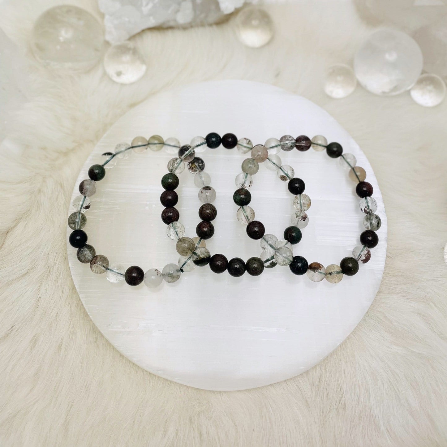 3 Lodolite bracelets on a table.