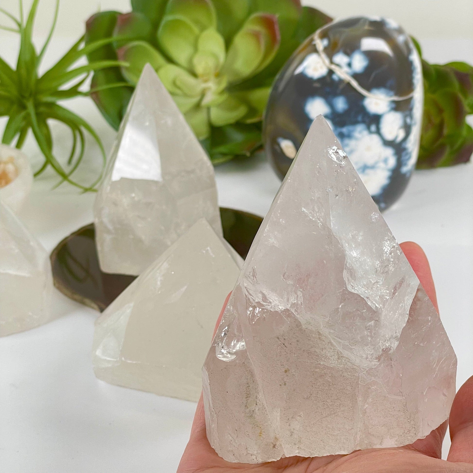 Crystal Quartz Semi Polished Point - As Is - You Choose one in hand for size reference with other variants in the background