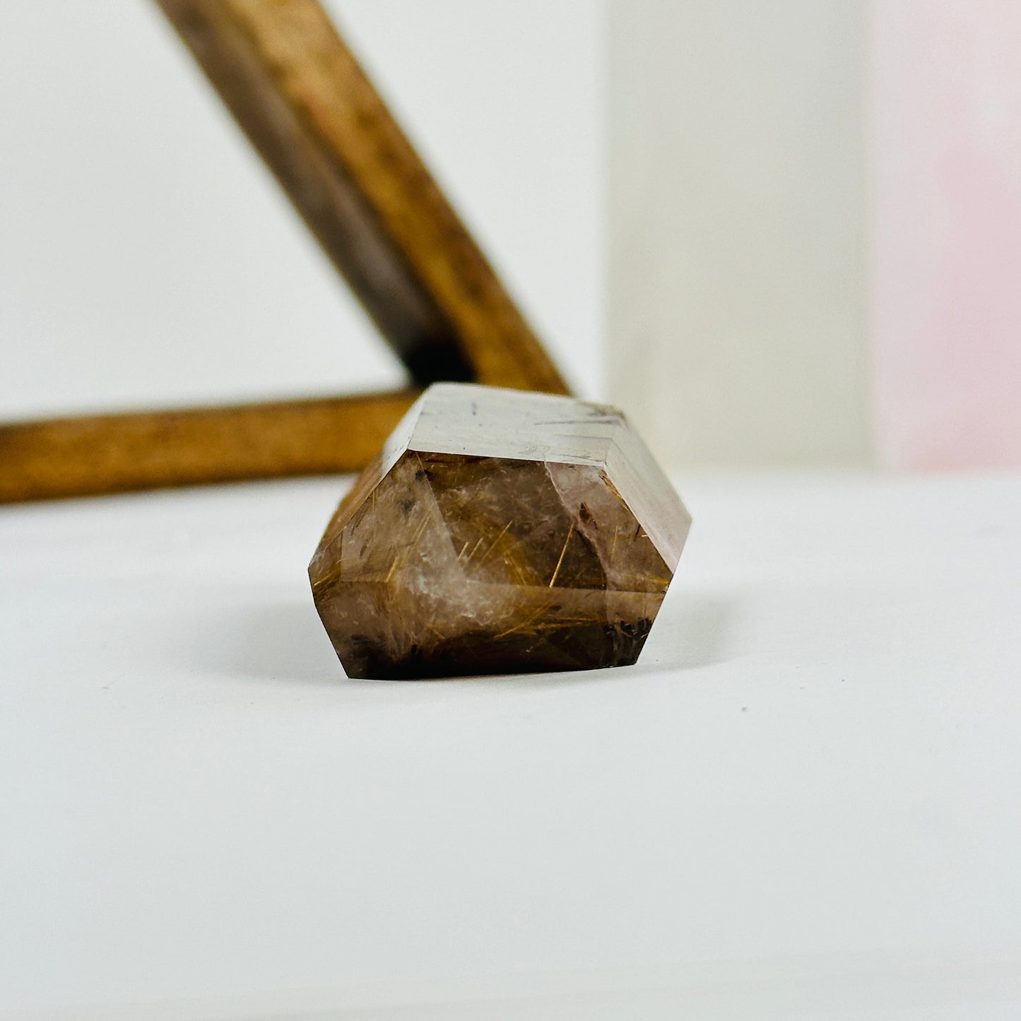 rutilated quartz with decorations in the background