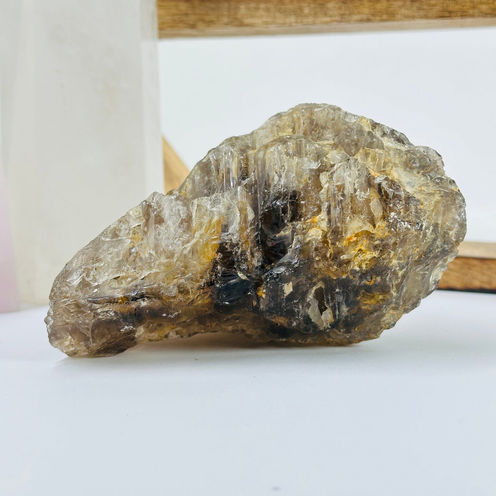 smoky quartz cluster with decorations in the background