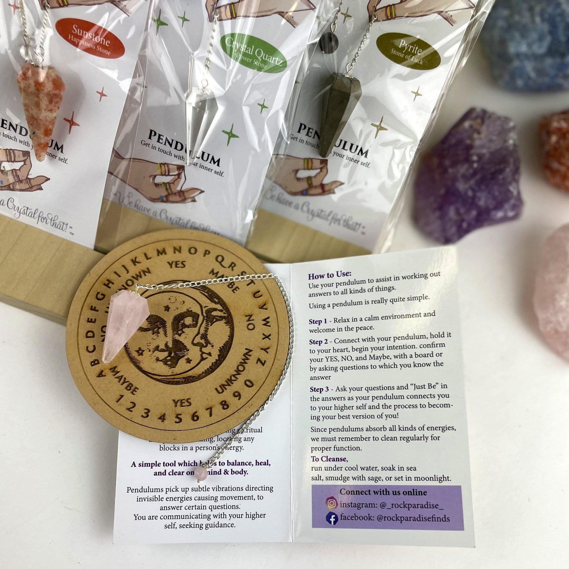 rose quartz crystal pendulum on information card