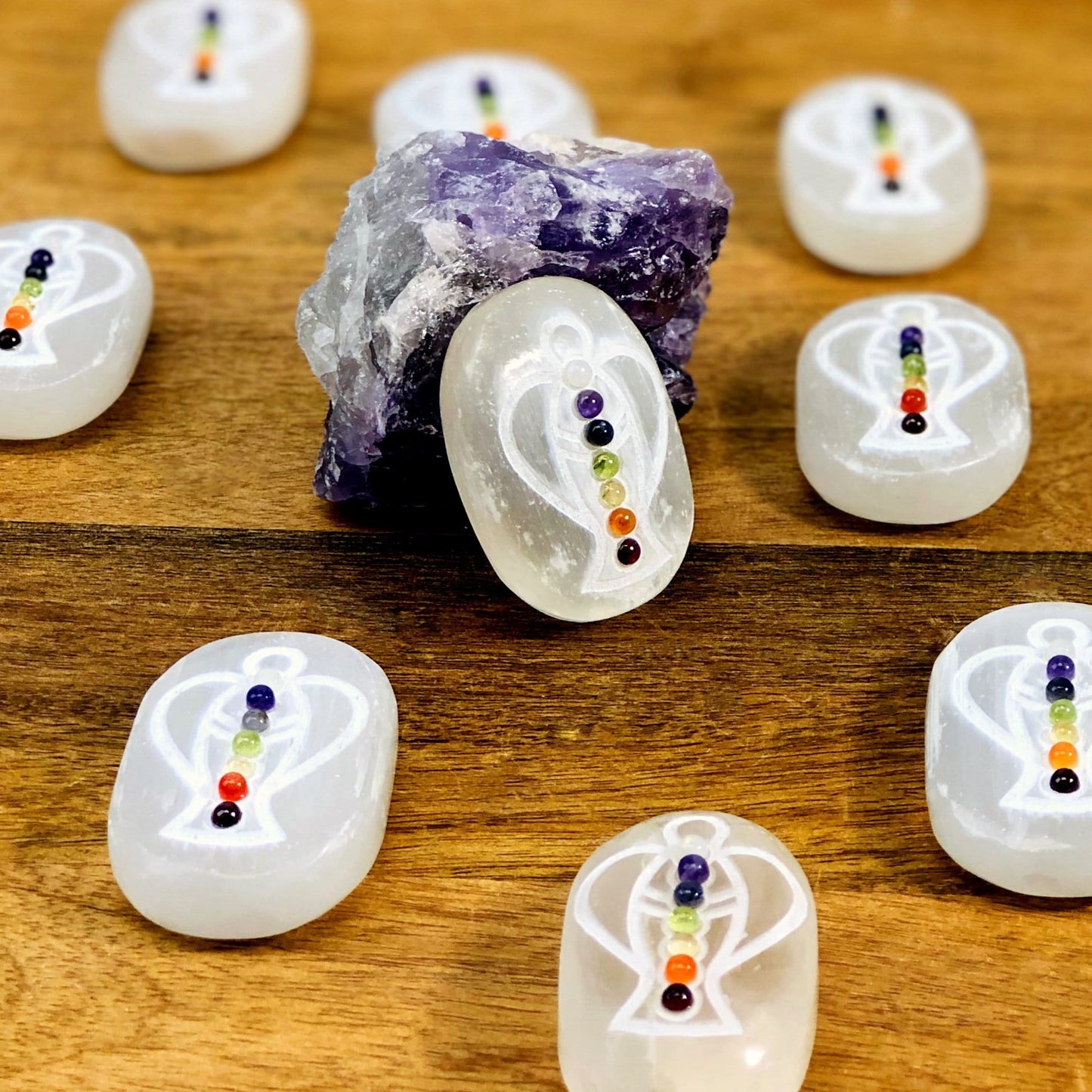 selenite palm stones on display with one propped up