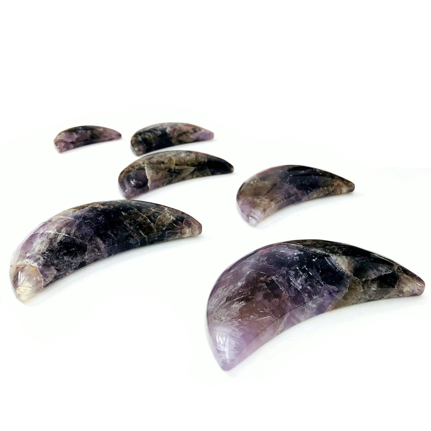 angled view of seven minerals in one polished moons for thickness