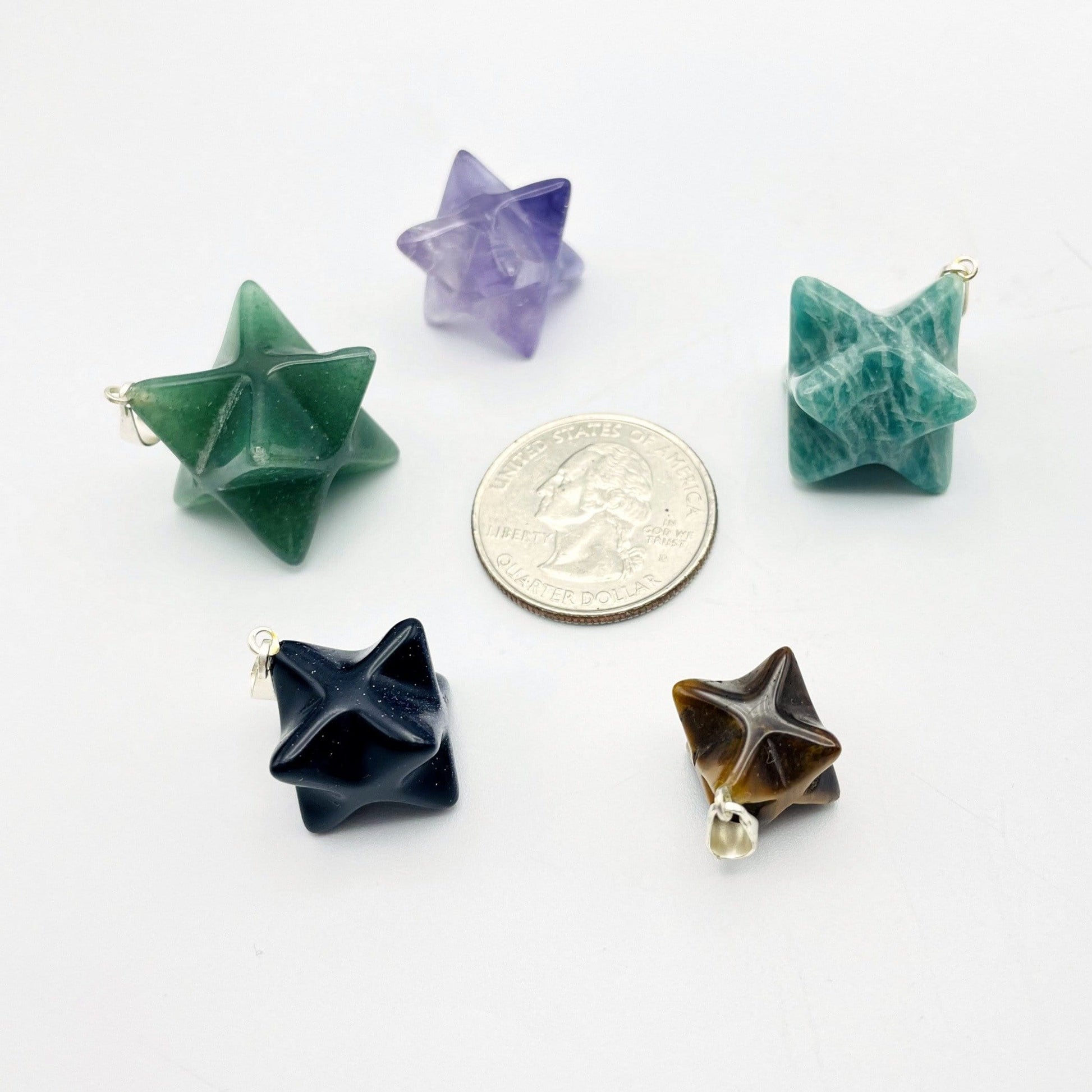 pendant displayed next to quarter for size reference