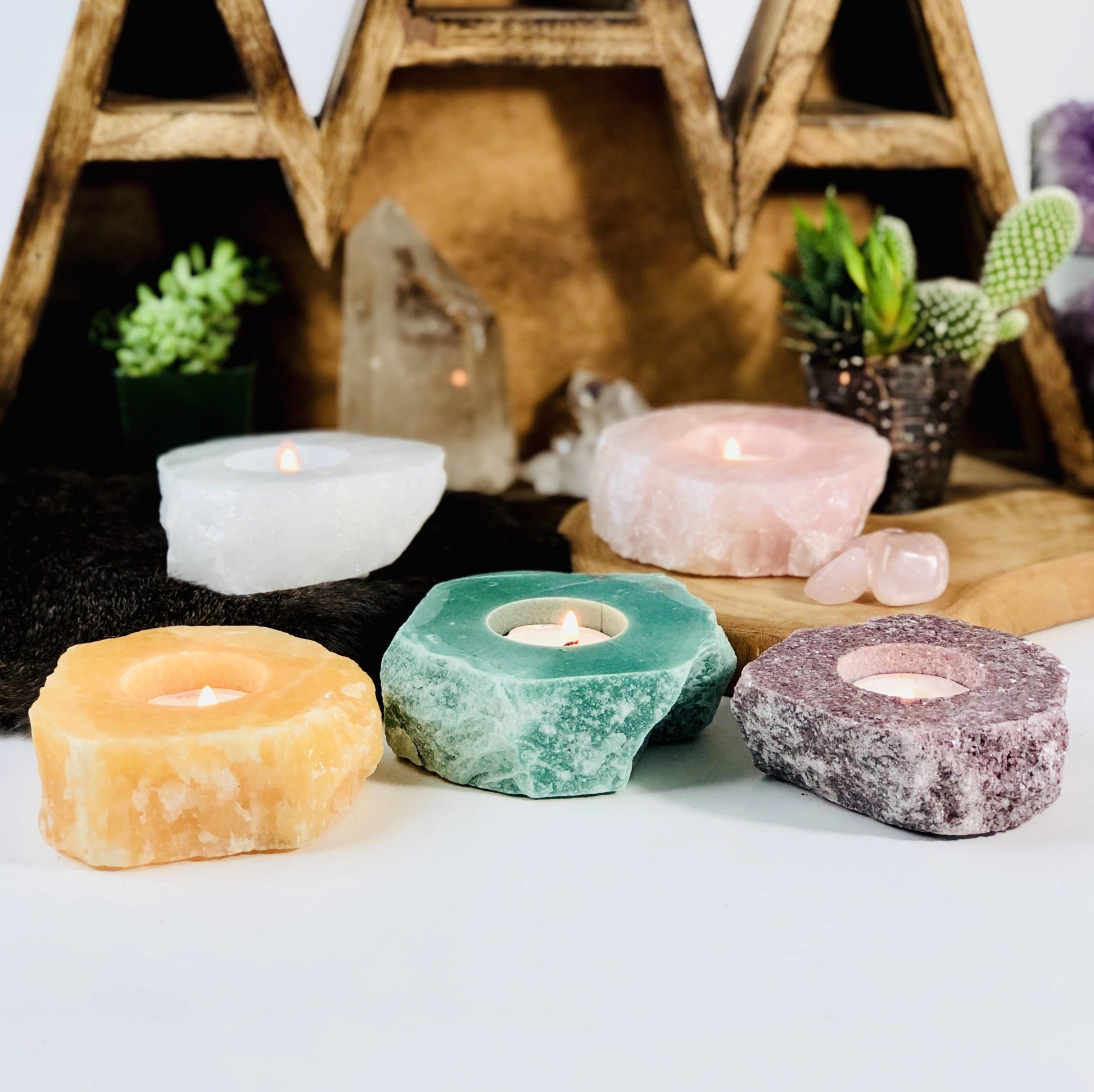 Side view of Rough Stone Candle Holder in different crystals with decorations in the background