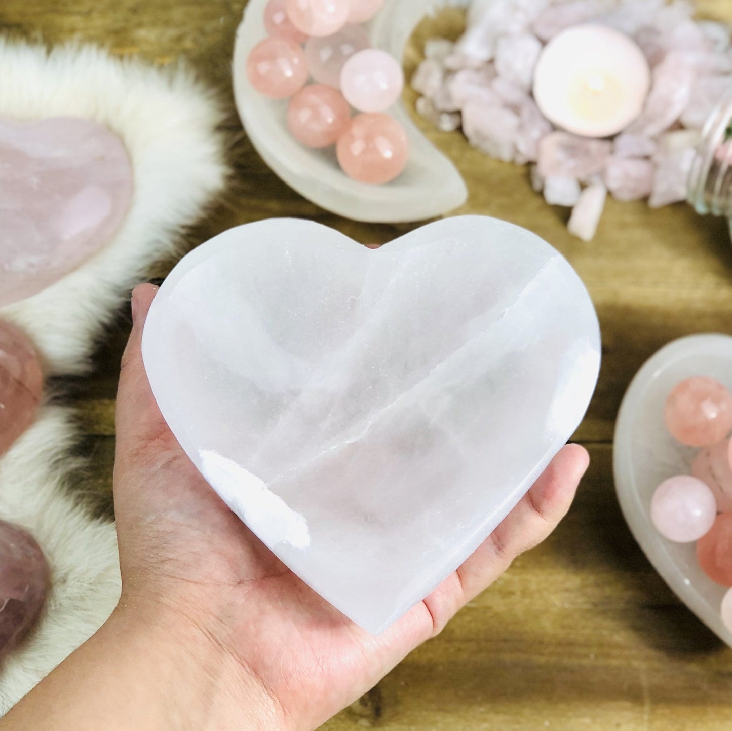 hand holding heart shaped selenite bowl