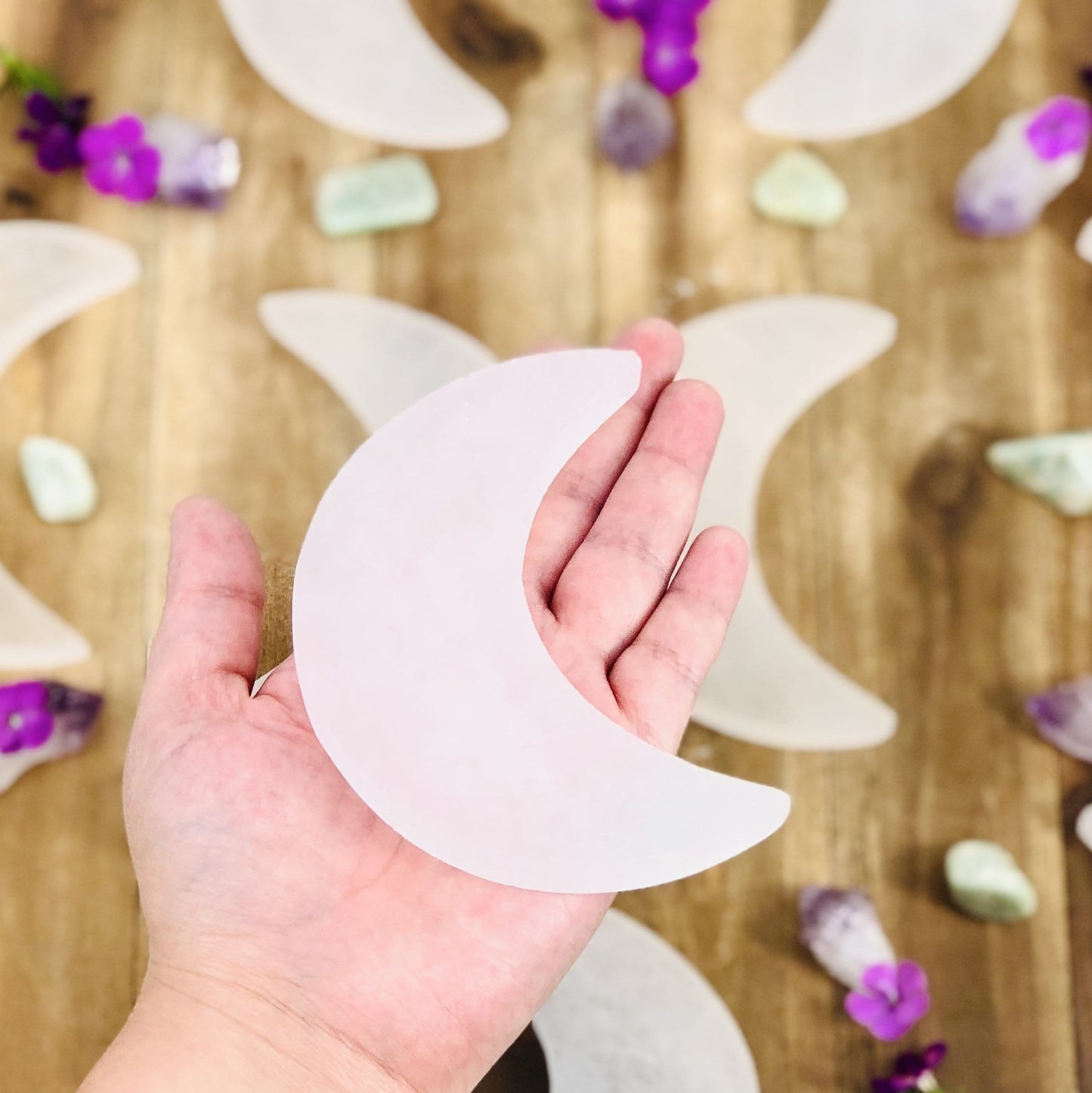selenite moon slice in hand for size reference 