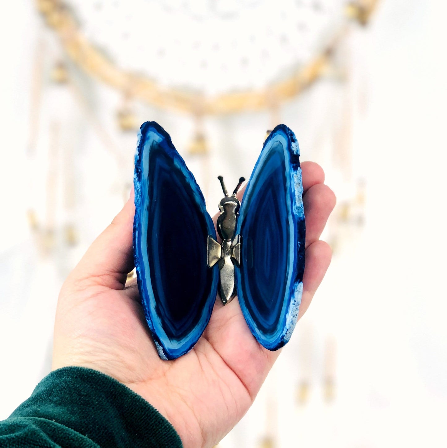 Agate Druzy Butterfly Stand in a hand.