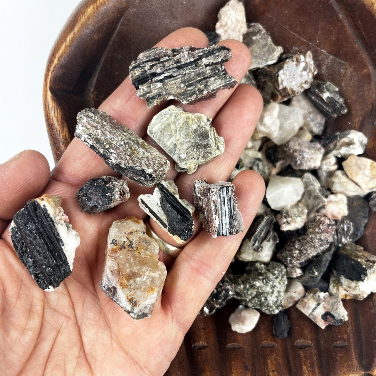 Black Tourmaline on Matrix Rough Stones - 1 LB Bag with some in a hand to show size and variation
