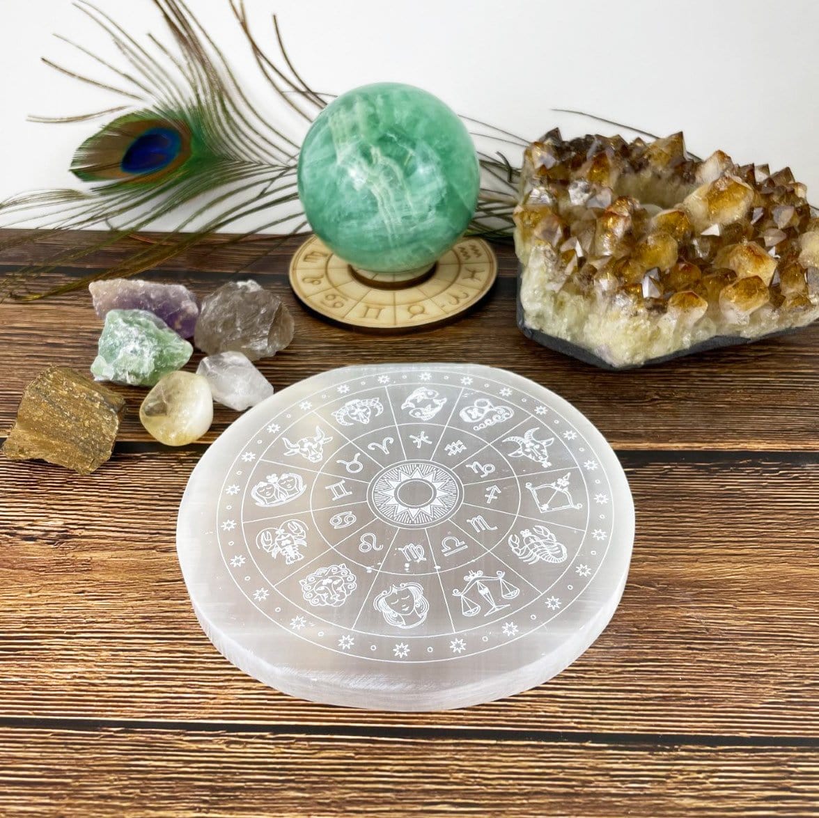 selenite zodiac engraved charging plate on display