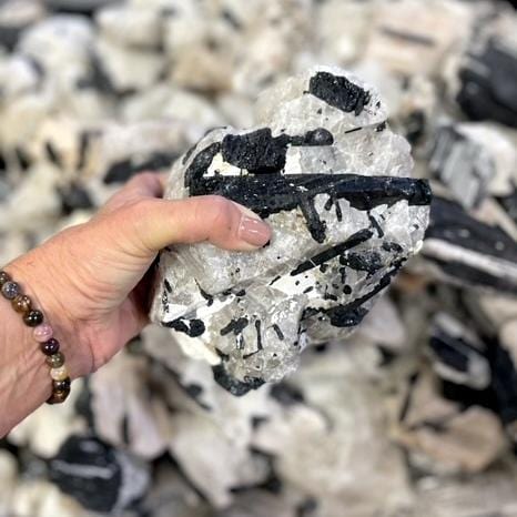 large tourmaline in hand for size reference