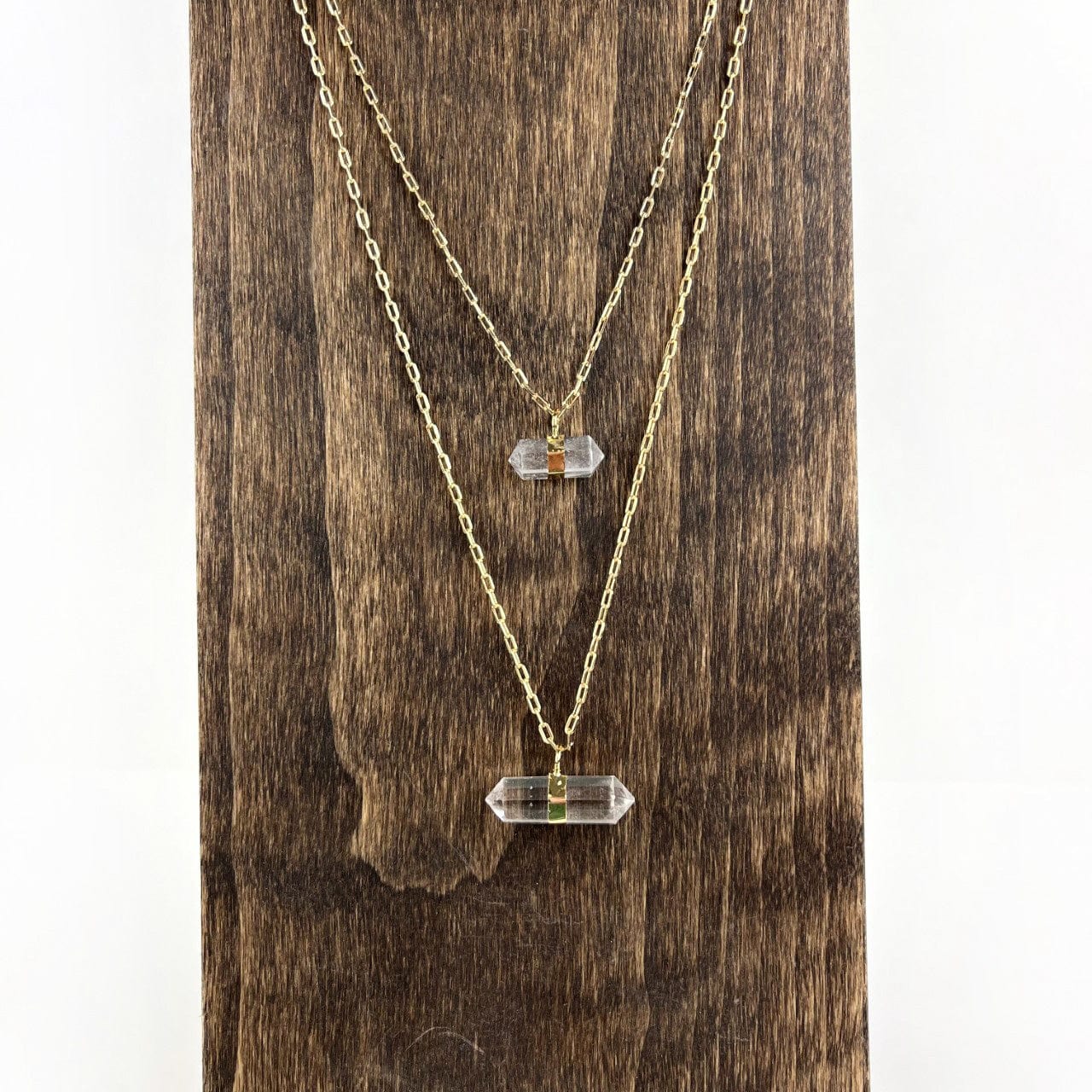 Crystal Point Necklace in gold on wood stand