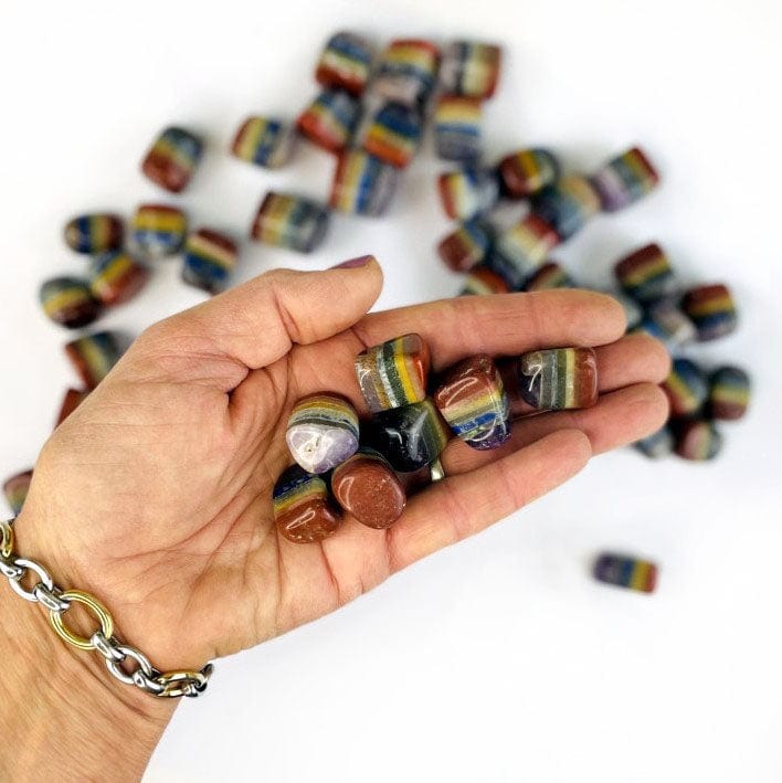 Bonded 7 chakra Stones  in a handwith others in the background