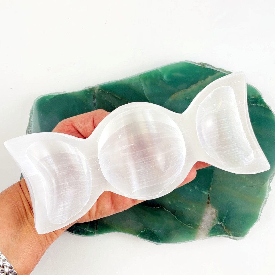 Selenite Triple Moon Goddess Bowl - Moon Phase Charging Station in a hand for sizing