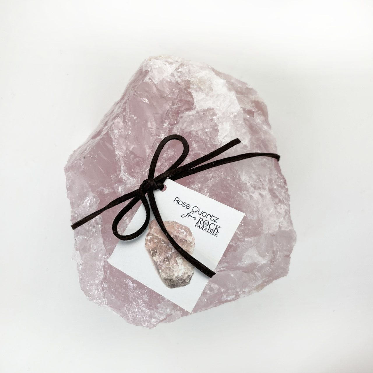 Rough rose quartz super sized stone tied and tagged with stone info card