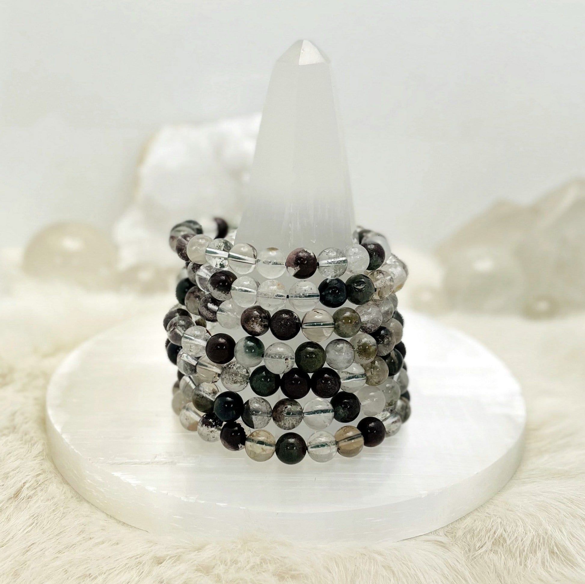 Lodolite bracelets stacked on a stand.