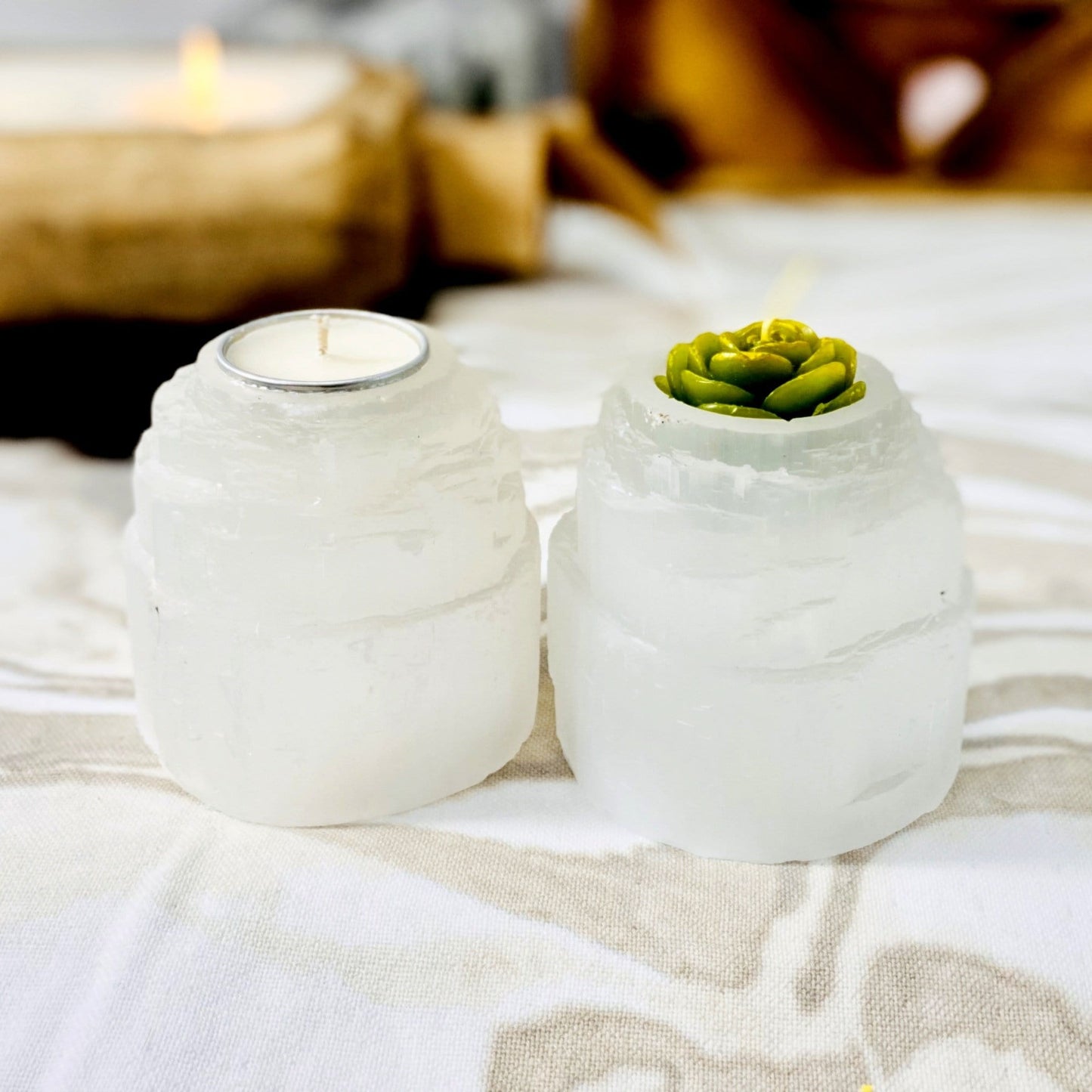 two selenite candle holders on display with candles (not included with purchase) for possible variations