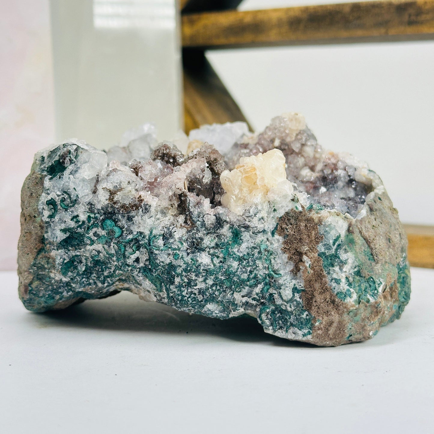 amethyst cluster with decorations in the background