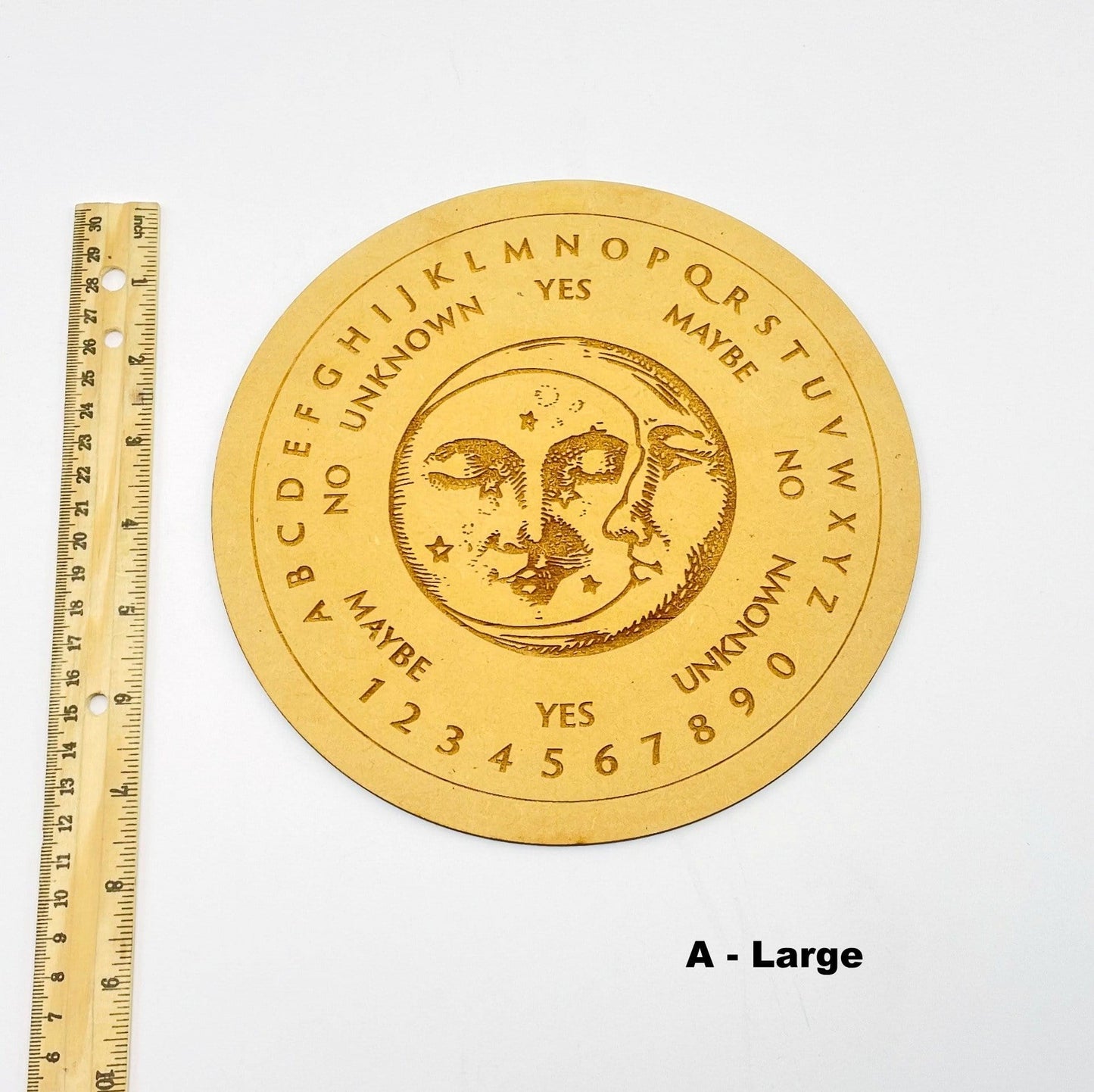 large board next to a ruler for size reference 