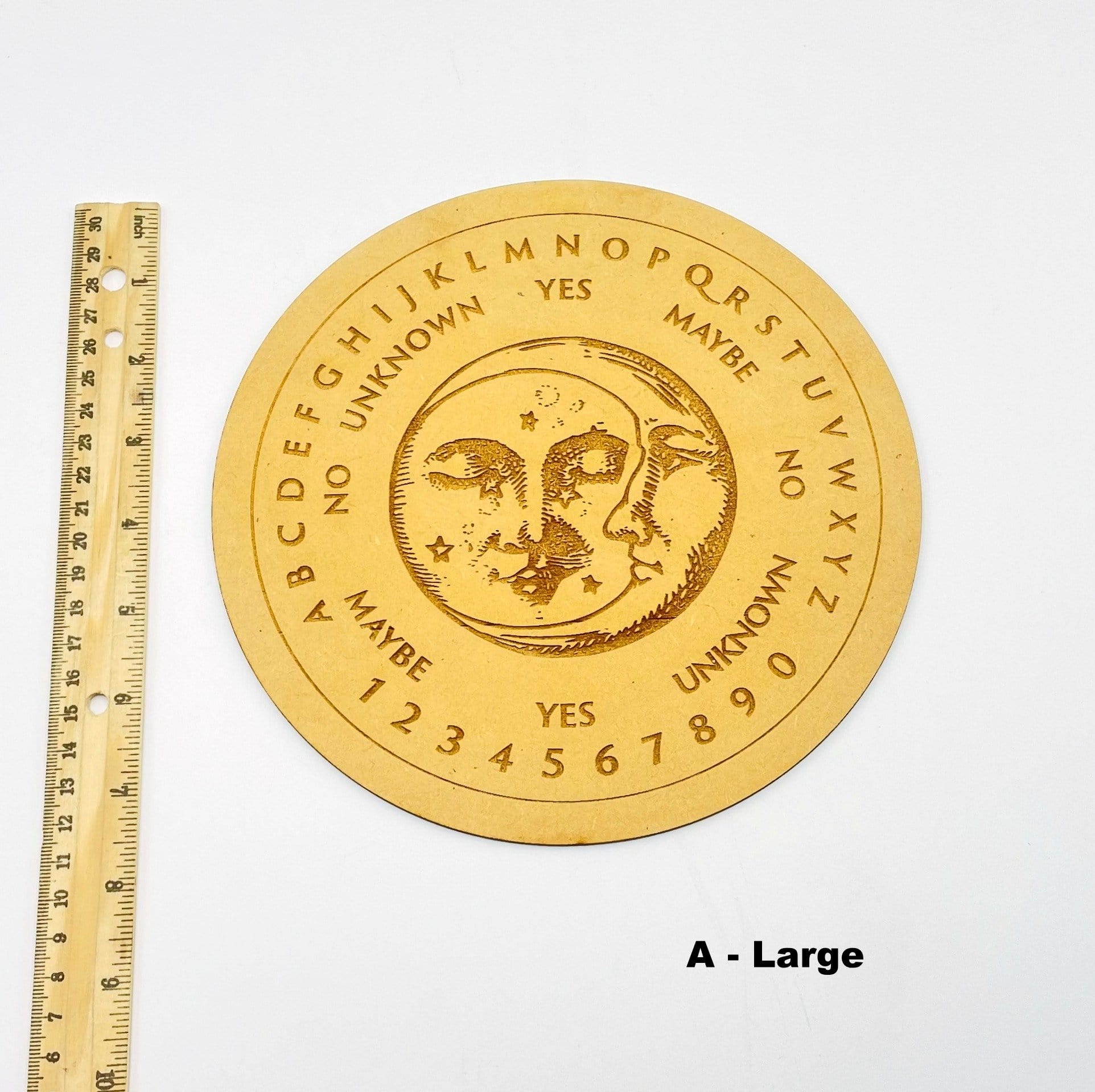 large board next to a ruler for size reference 