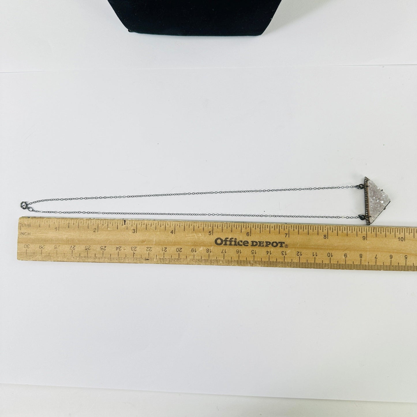 druzy pendant necklace next to a ruler for size reference