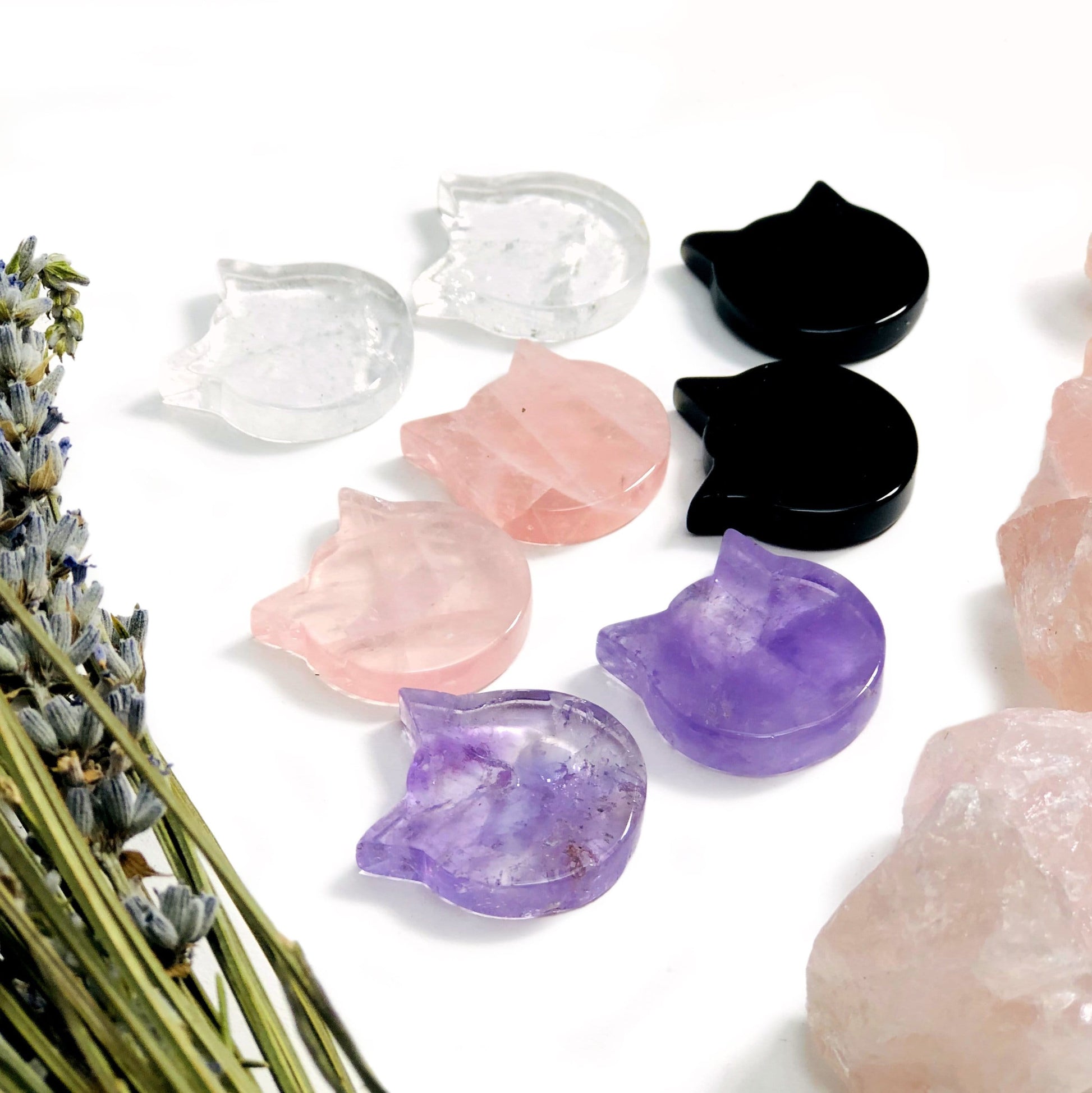 angled shot of 8 Gemstone Cats in different crystal types with decorations in the background