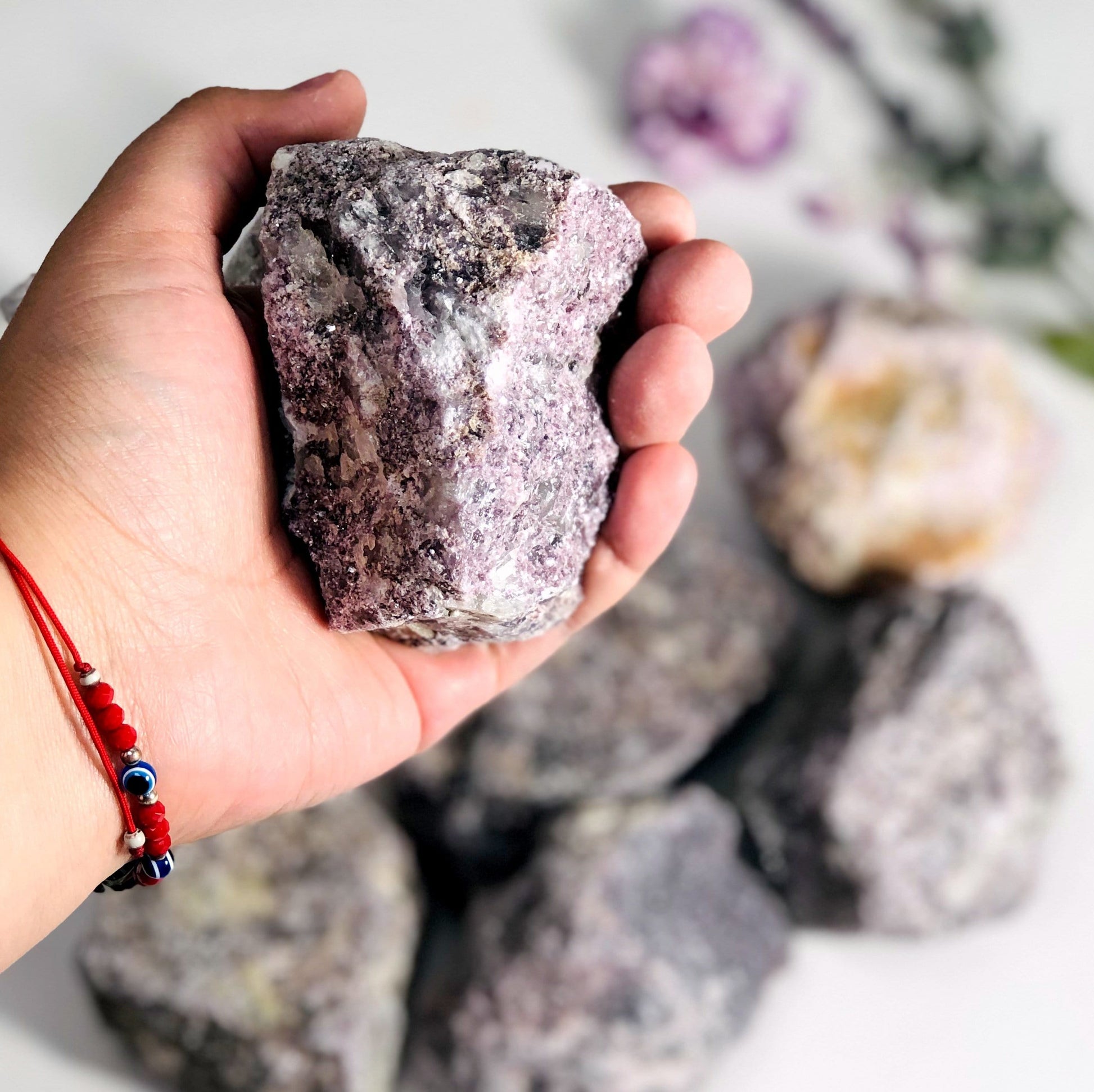 Lepidolite Rough Stone in hand for size color texture reference