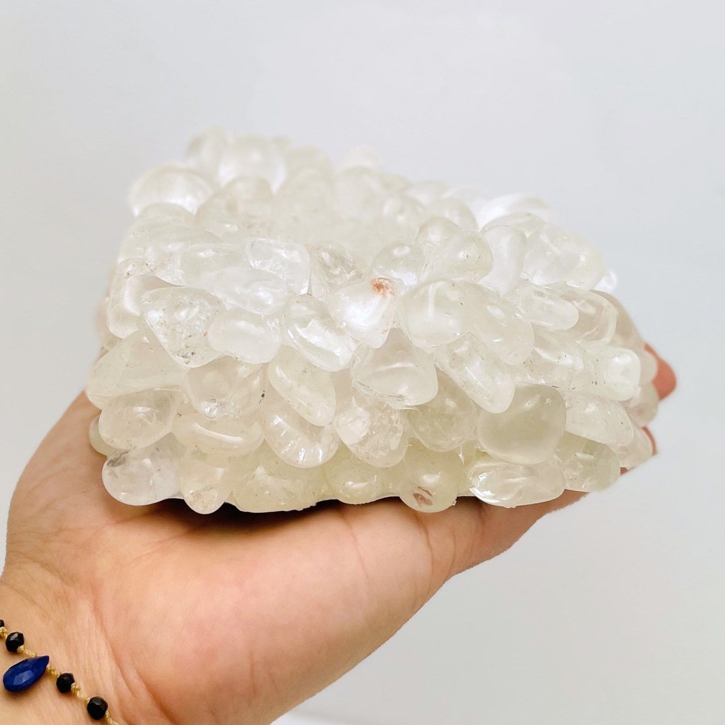 Heart shaped candle holder that is made with crystal quartz tumbled stones that are glued together.