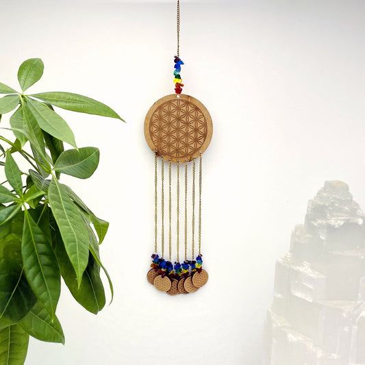 Beautiful Engraved Flower of Life on a wooden circle with attached mini engraved wood circles on white background.