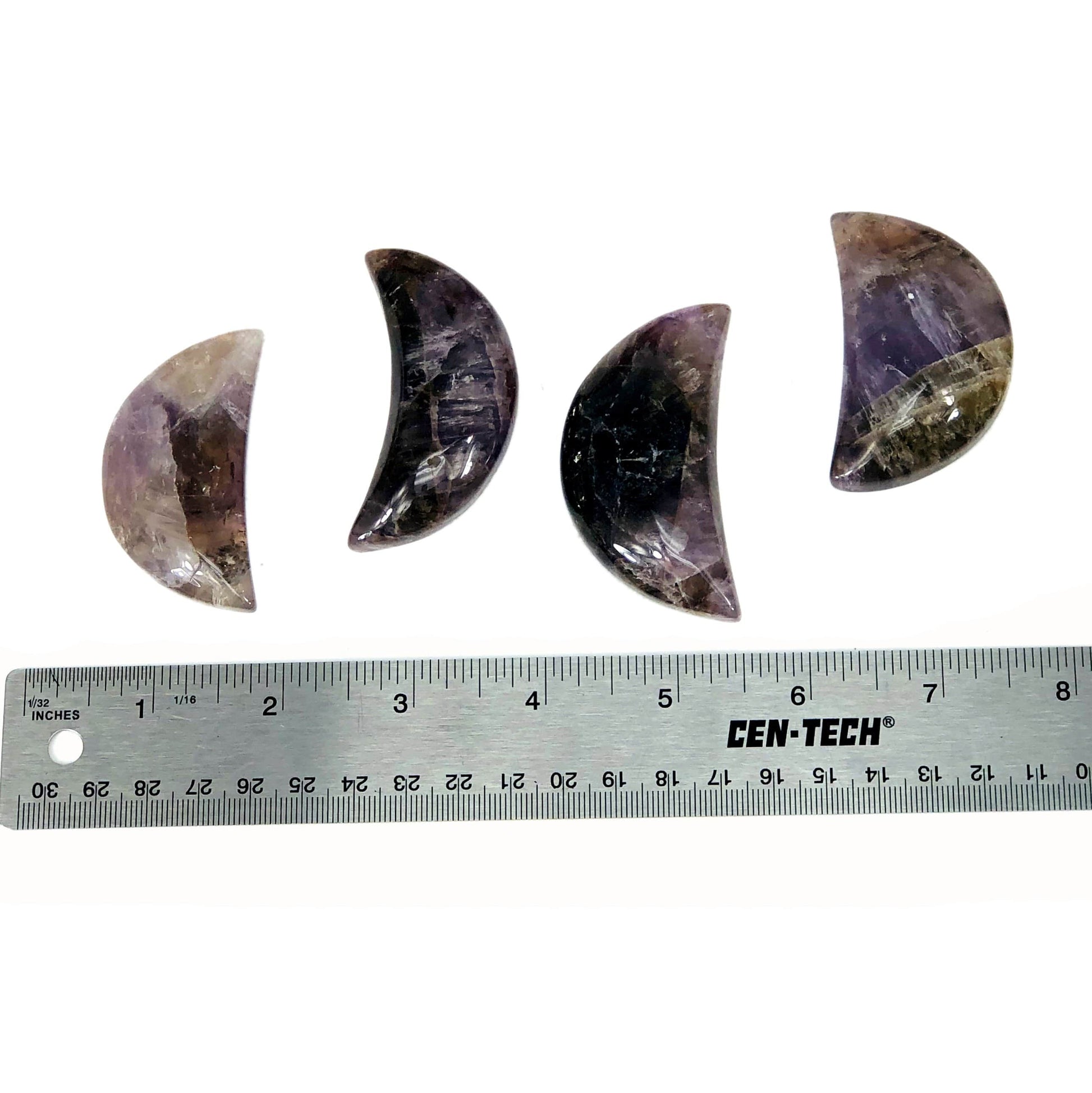 four seven minerals in one polished moons with ruler for size reference