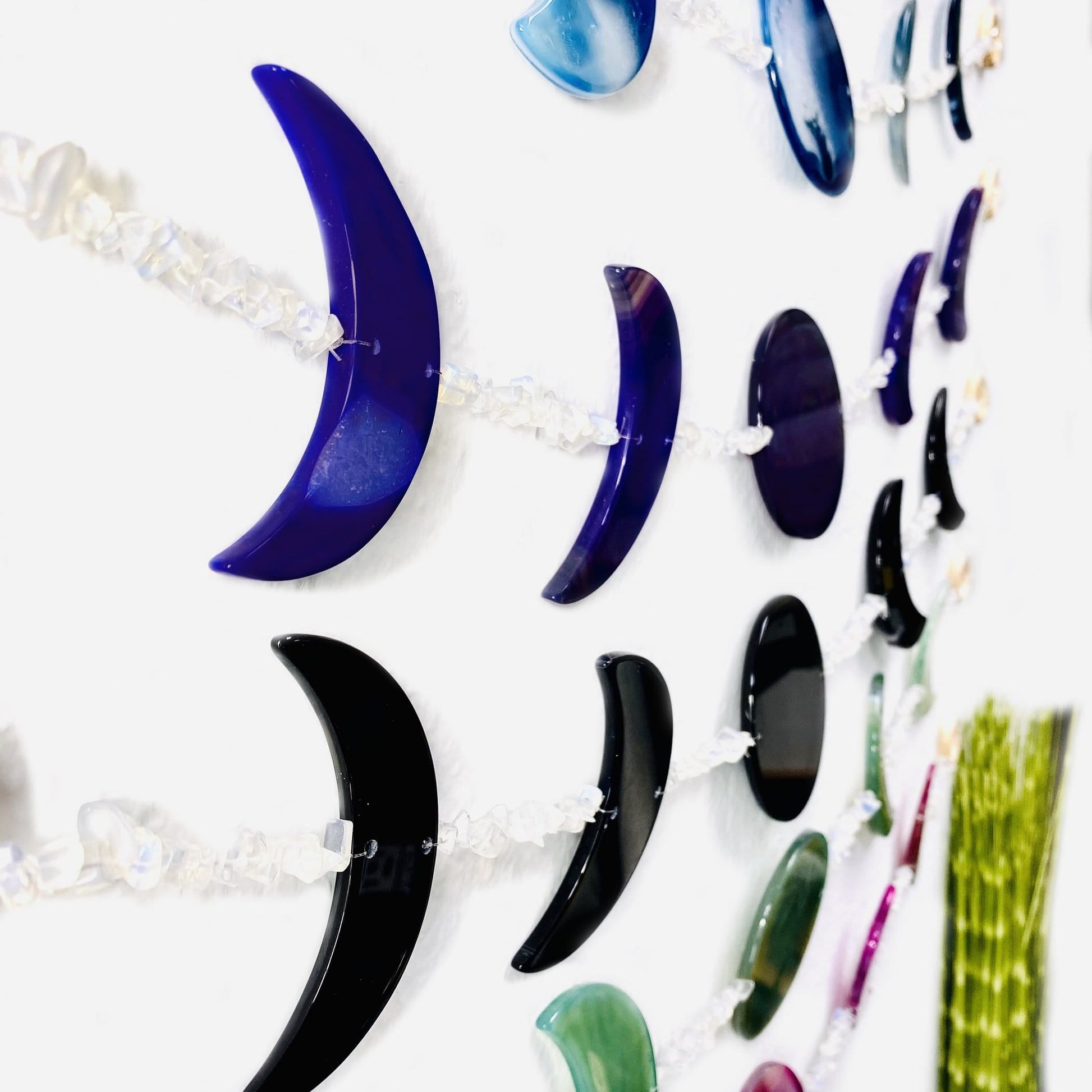 Side view of moon phase wall hanging