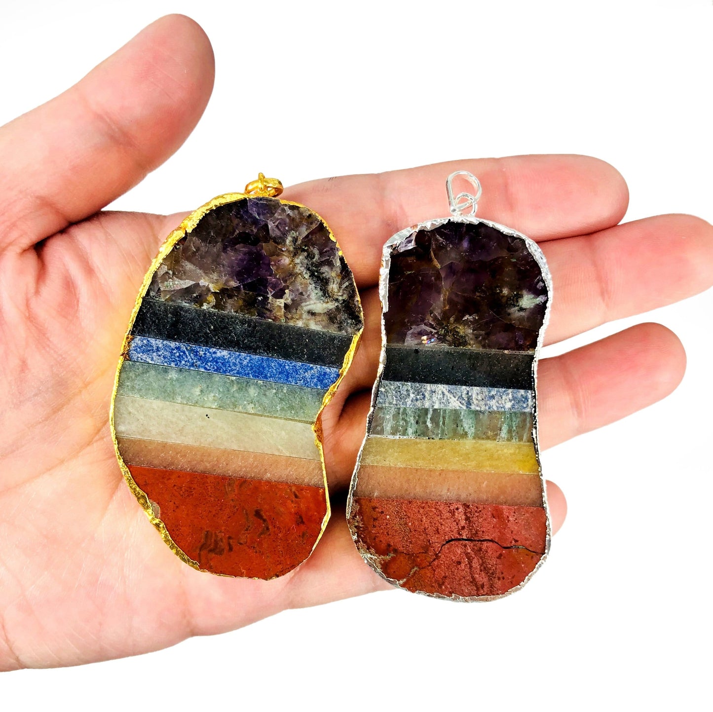 chakra pendants in hand for size reference 
