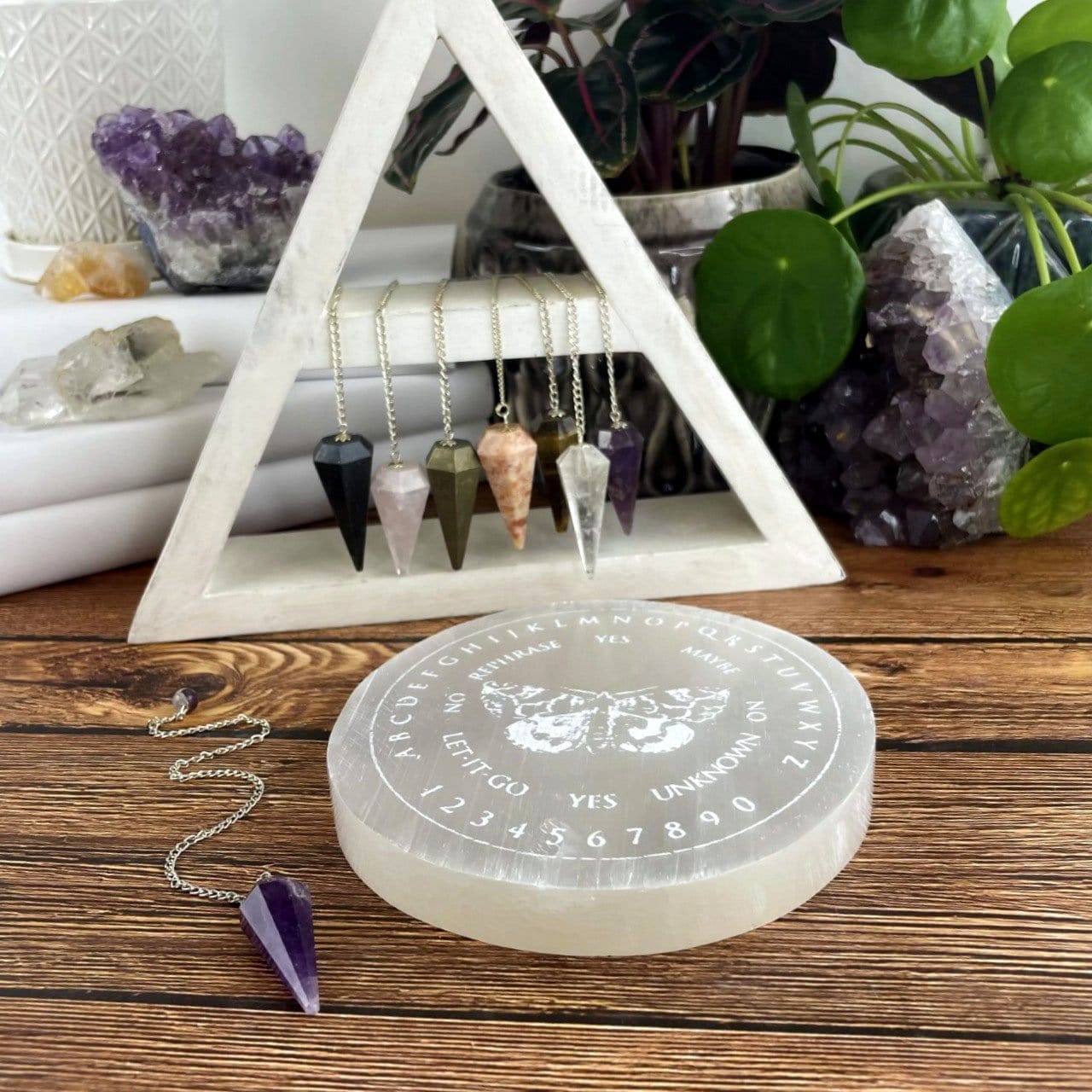 selenite moth pendulum board engraved charging plate on display