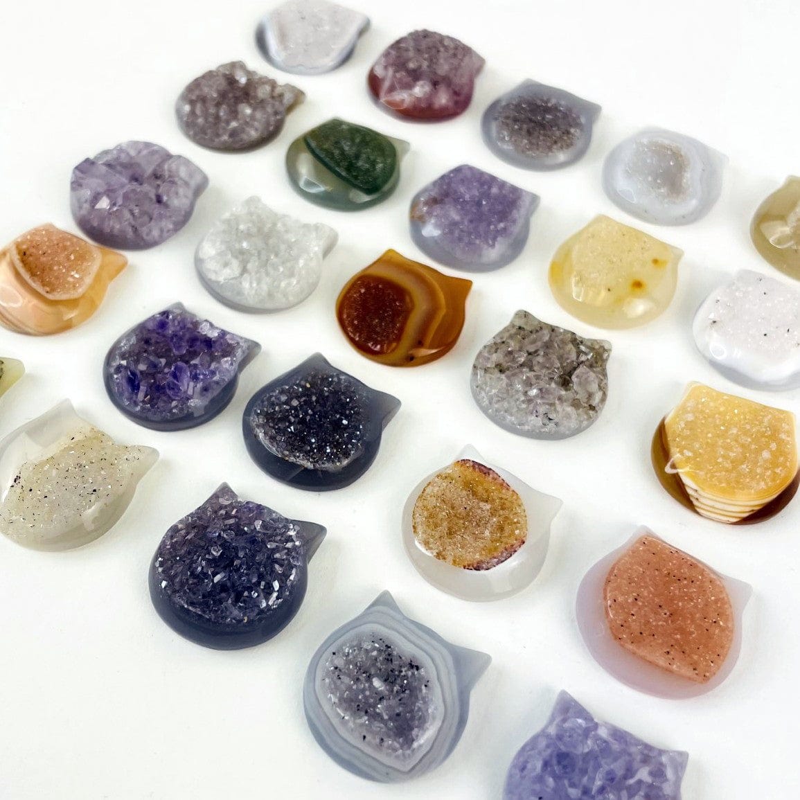 Close up of Agate Druzy Cat Heads on a white background.