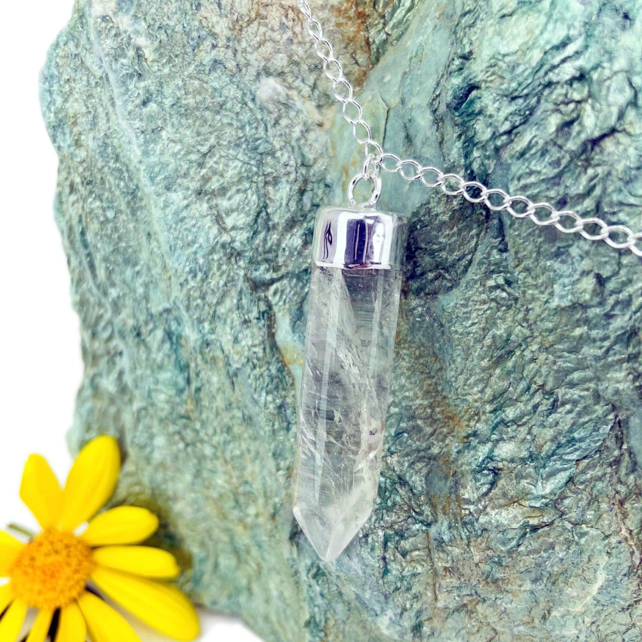 up close of a single point to show natural inclusions in the gemstone in silver
