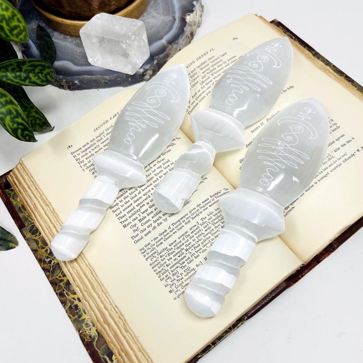selenite twisted handle knives with unalome engraving on display for possible variations