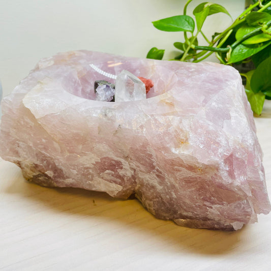 large rose quartz bowl displayed with some crystals to show how deep the bowl part is 