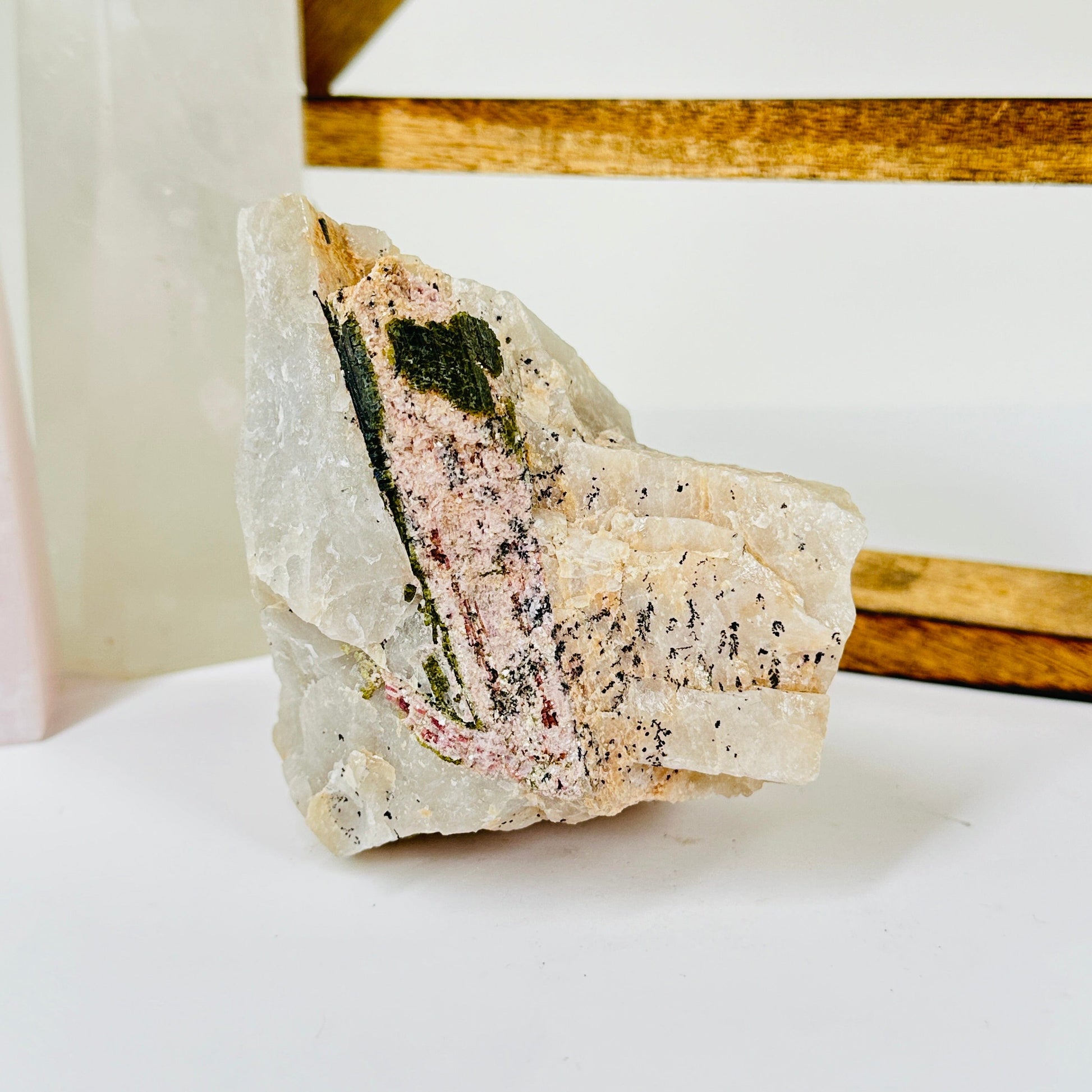 watermelon tourmaline with decorations in the background