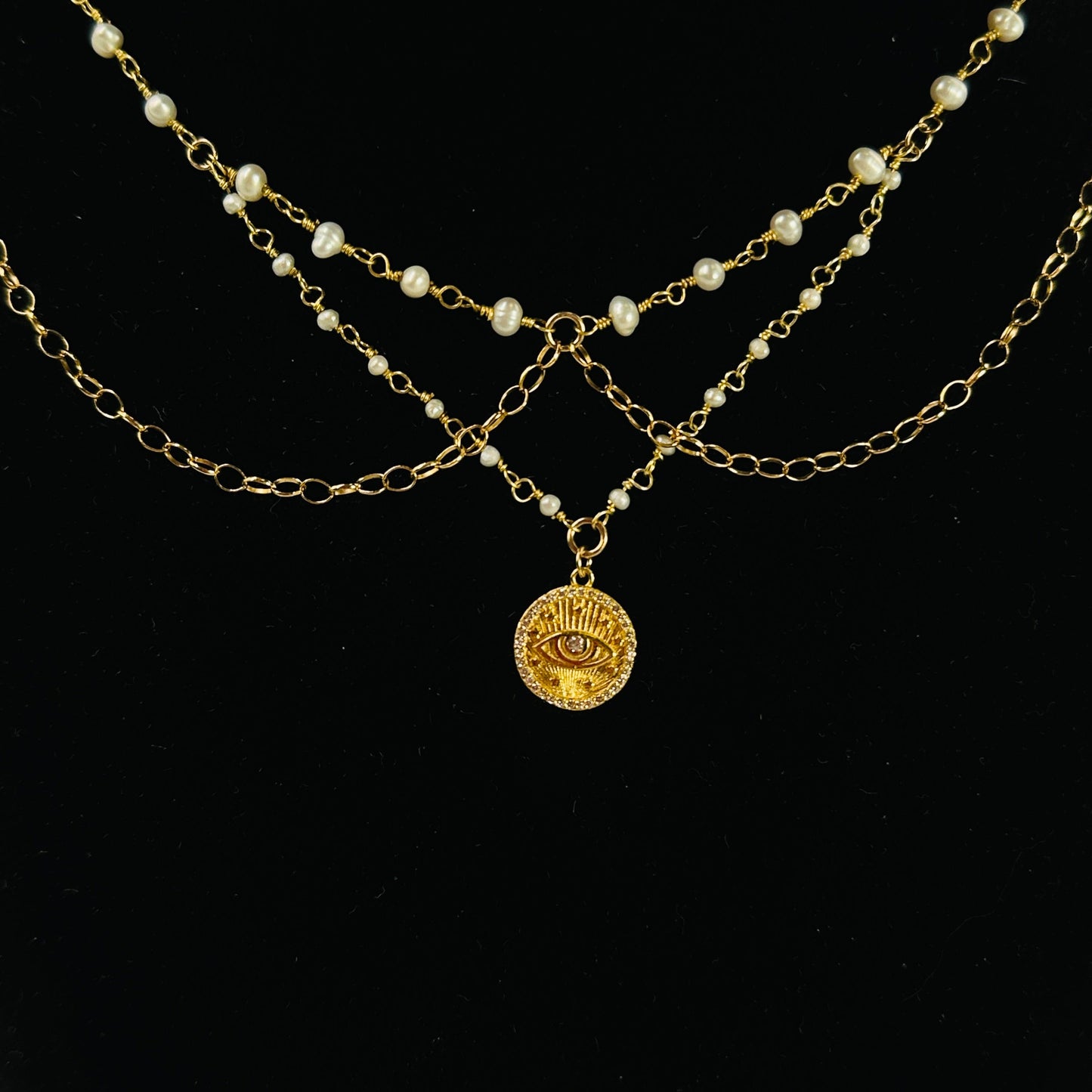 gold pearl necklace with decorations in the background