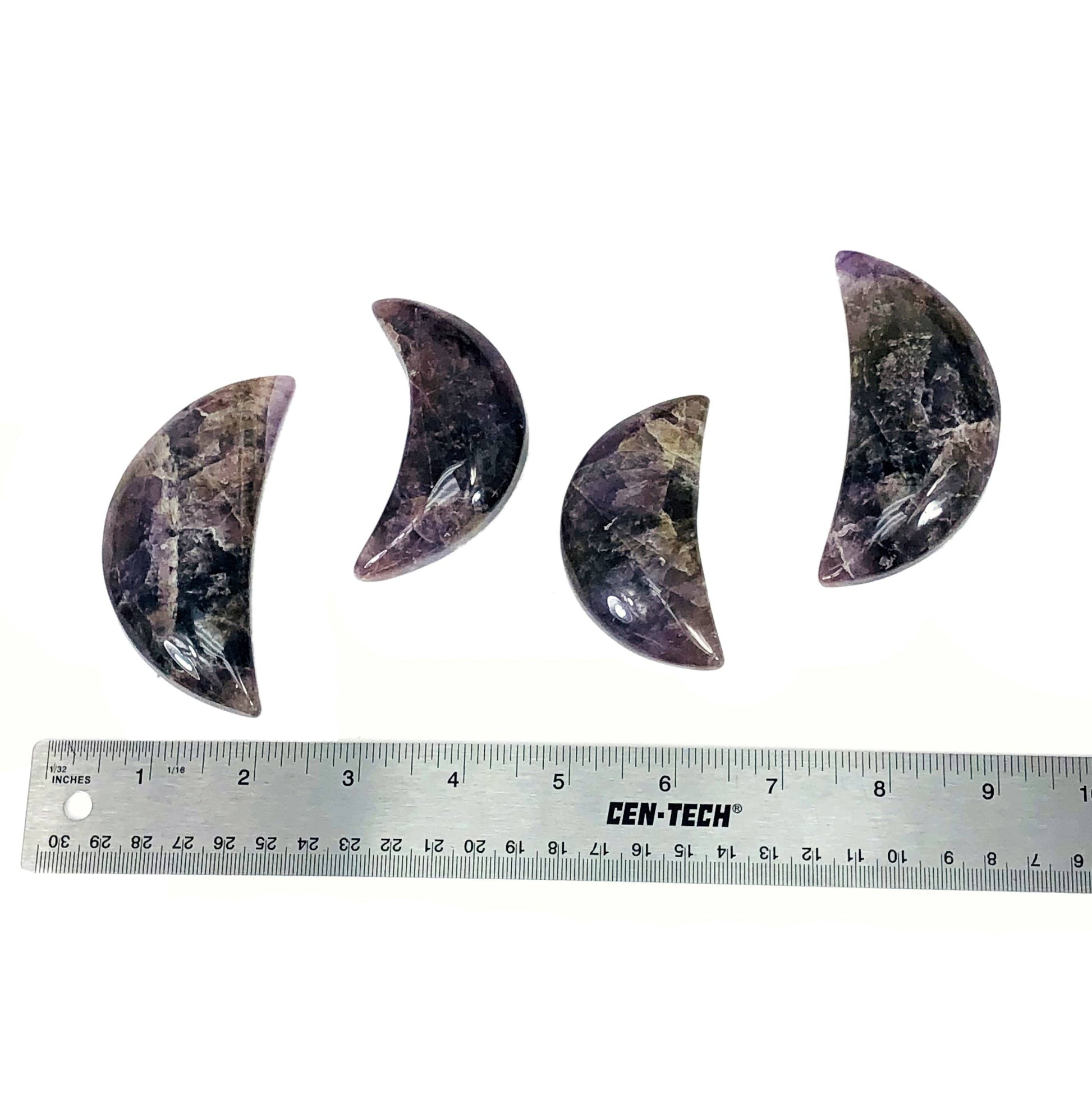 four seven minerals in one polished moons with ruler for size reference