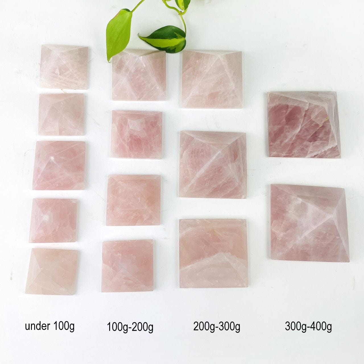 Rose Quartz Pyramids sorted  by size with sizes called out for size reference