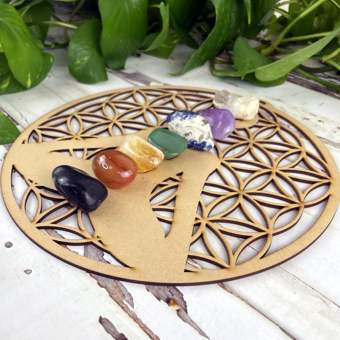Wood Crystal Grid with Flower of Life Cut outs and a cut out of a person sitting in meditation pose.