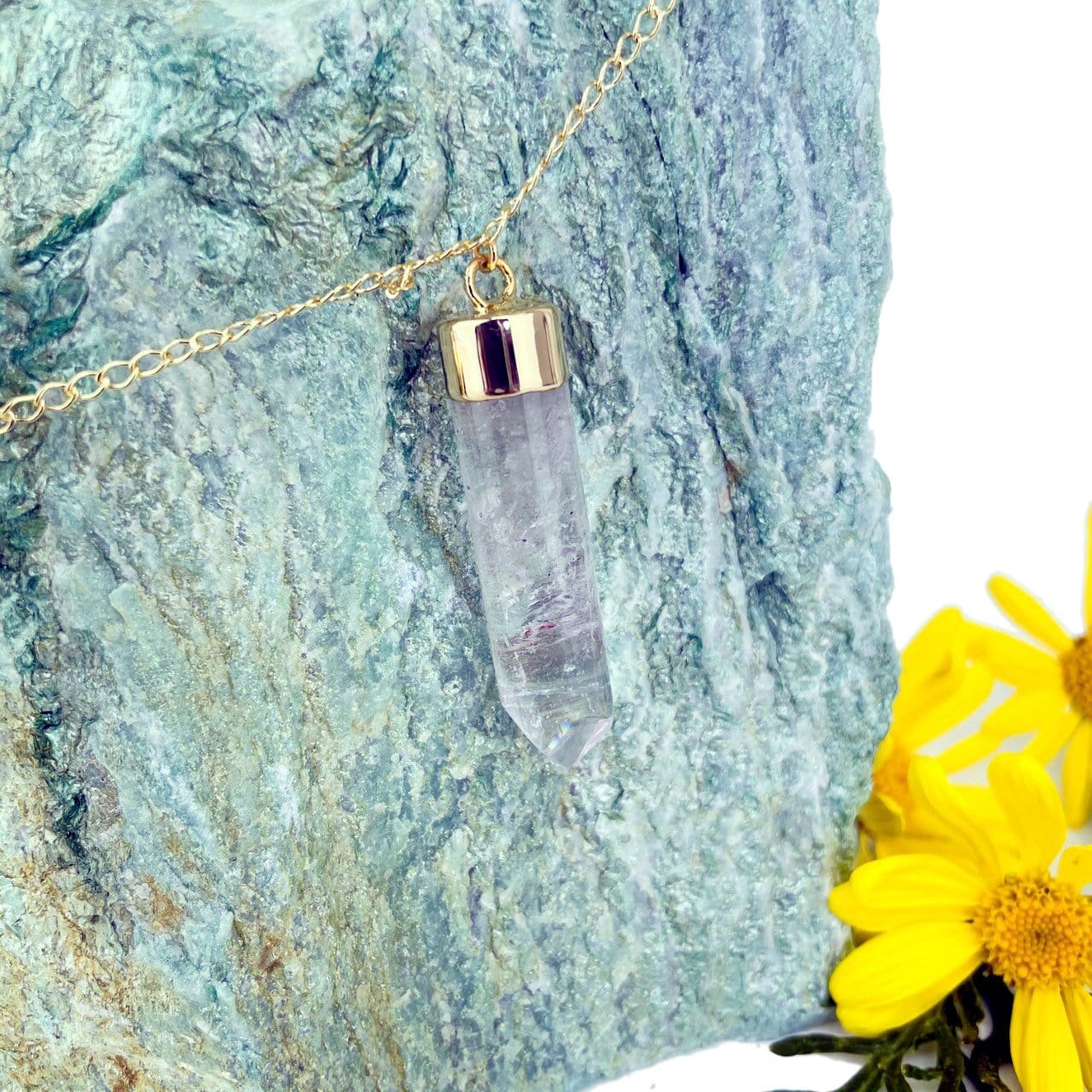 up close of a single point to show natural inclusions in the gemstone in gold