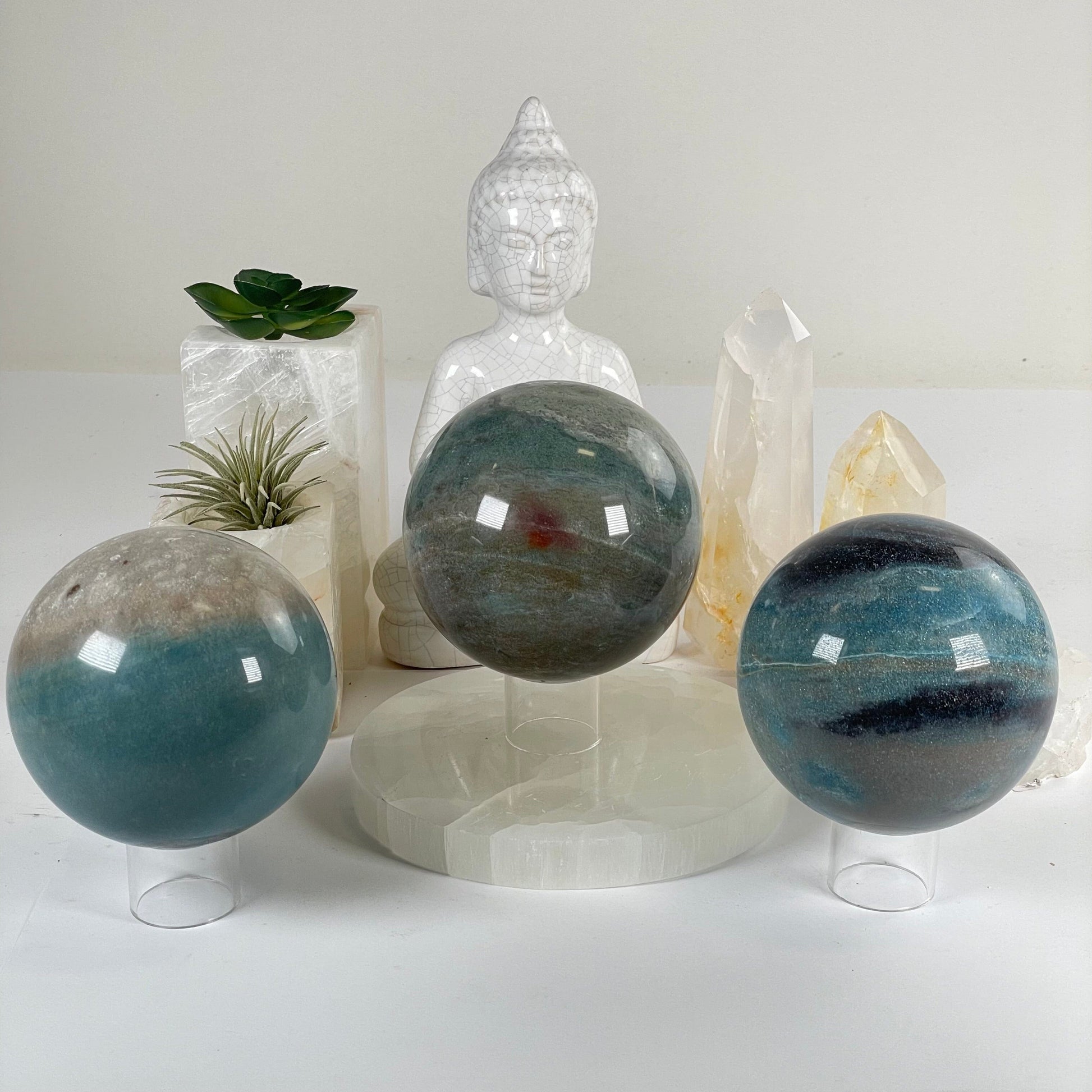 Trolleite Large Crystal Sphere - You Choose #2 all variants front view with props and plants in the background
