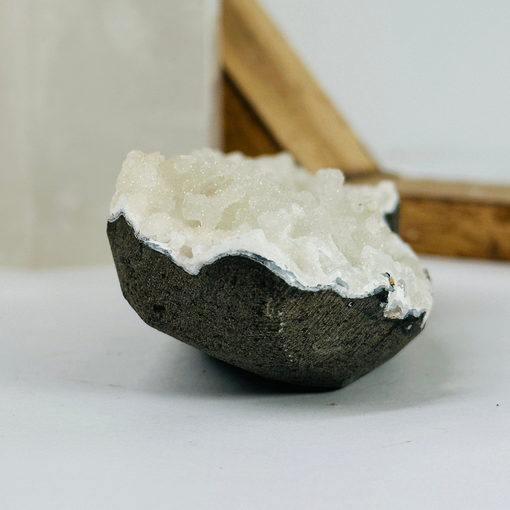 apophyllite on matrix with decorations in the background
