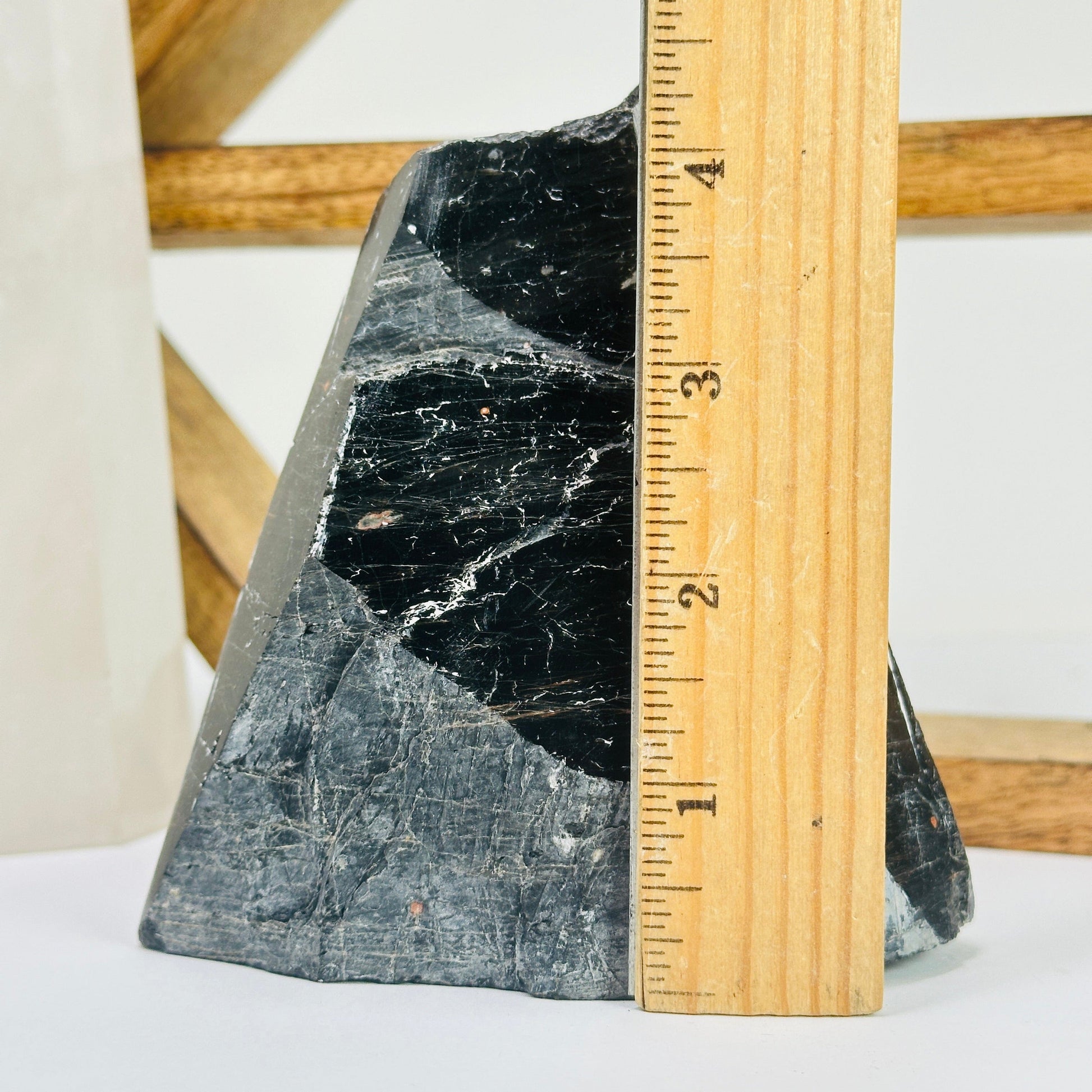 tourmaline point next to a ruler for size reference
